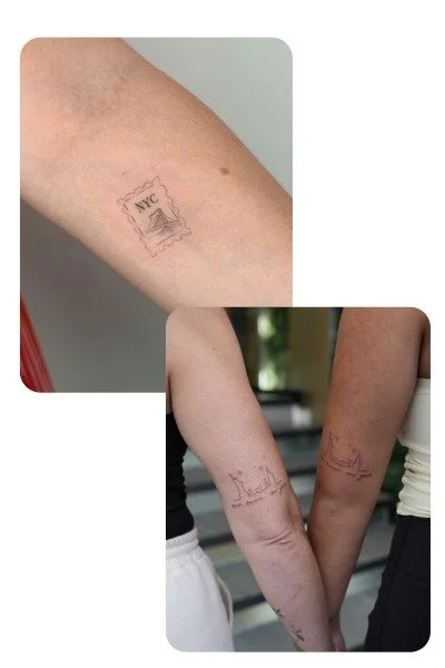 Two people with matching small tattoos on their arms, including NYC and a boat, holding hands.