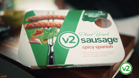 Package of plant-based spicy Spanish sausage with image of sausages and green leaves on the packaging.