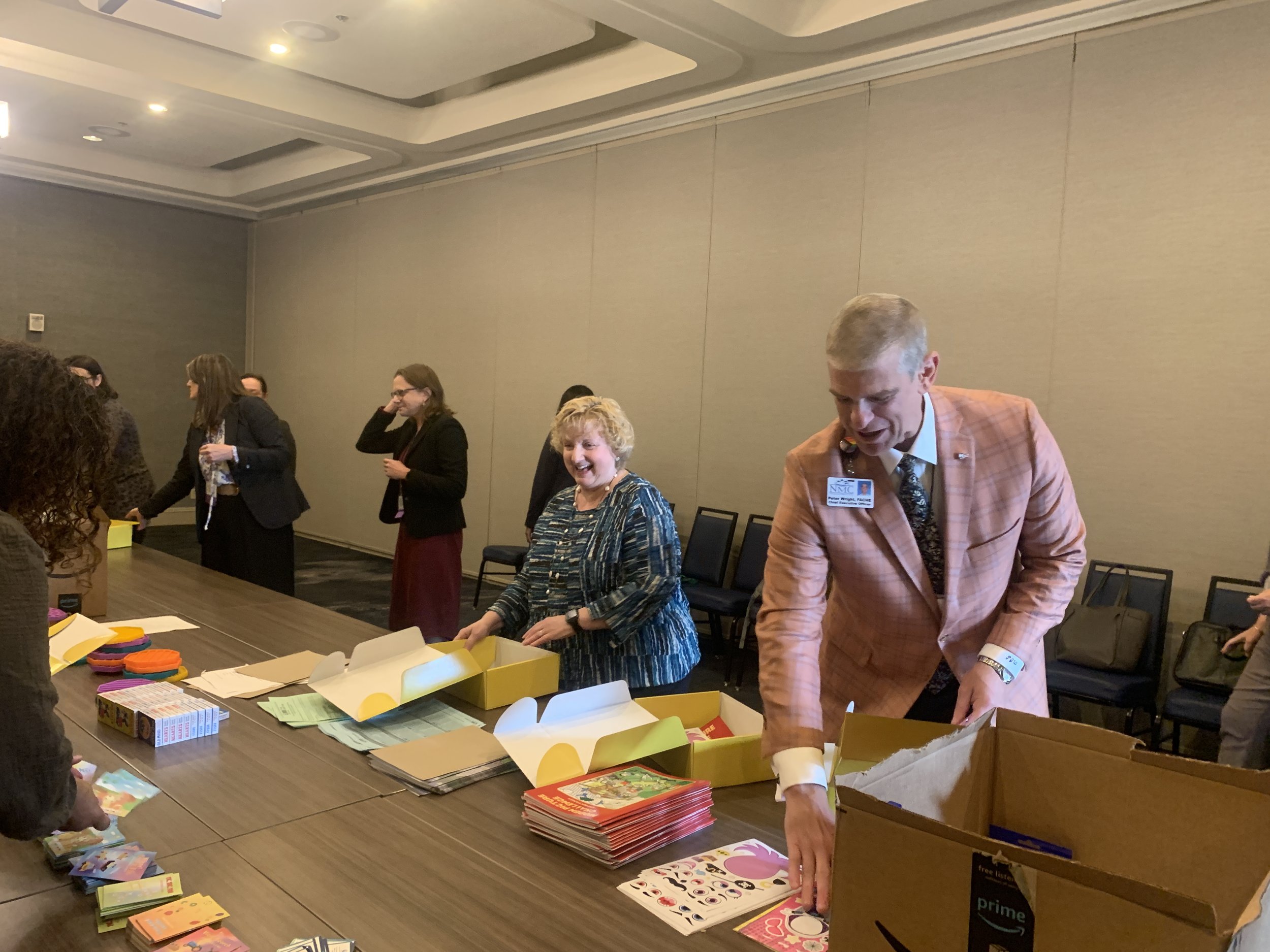  Anna Noonan, President and COO of University of Vermont Health Network-Central Vermont Medical Center, and Peter Wright, CEO of Northwestern Medical Center, and others assemble kits for children in hospital emergency departments.  