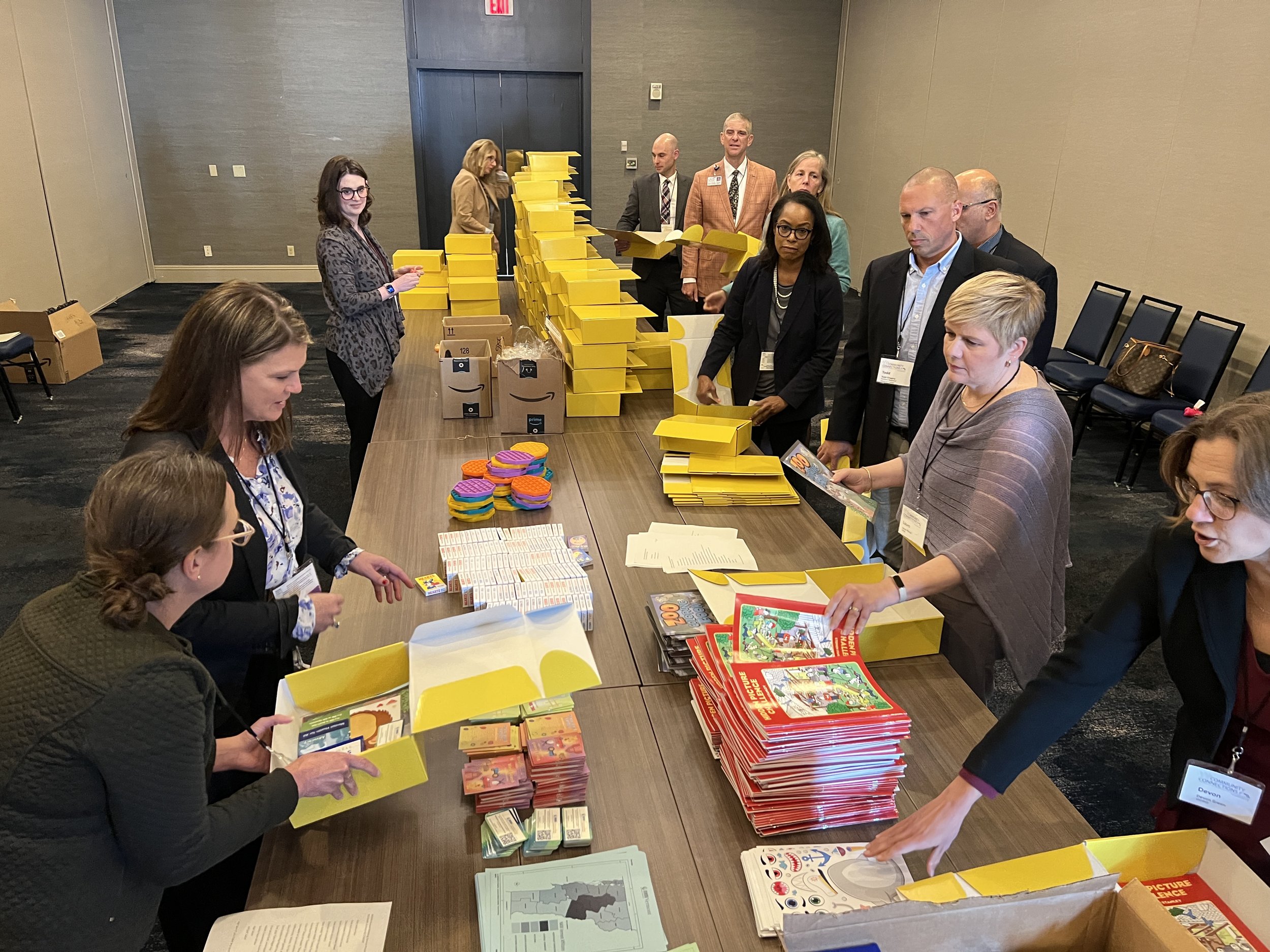  Hospital leaders, with VAHHS staff and board members, assemble kits for children in Vermont’s emergency departments. 