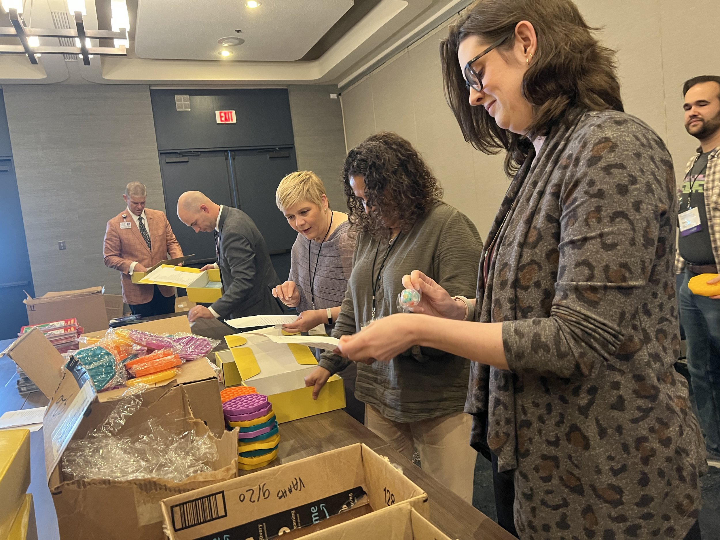  Hospital leaders, with VAHHS staff and board members, assemble kits for children in Vermont’s emergency departments. 