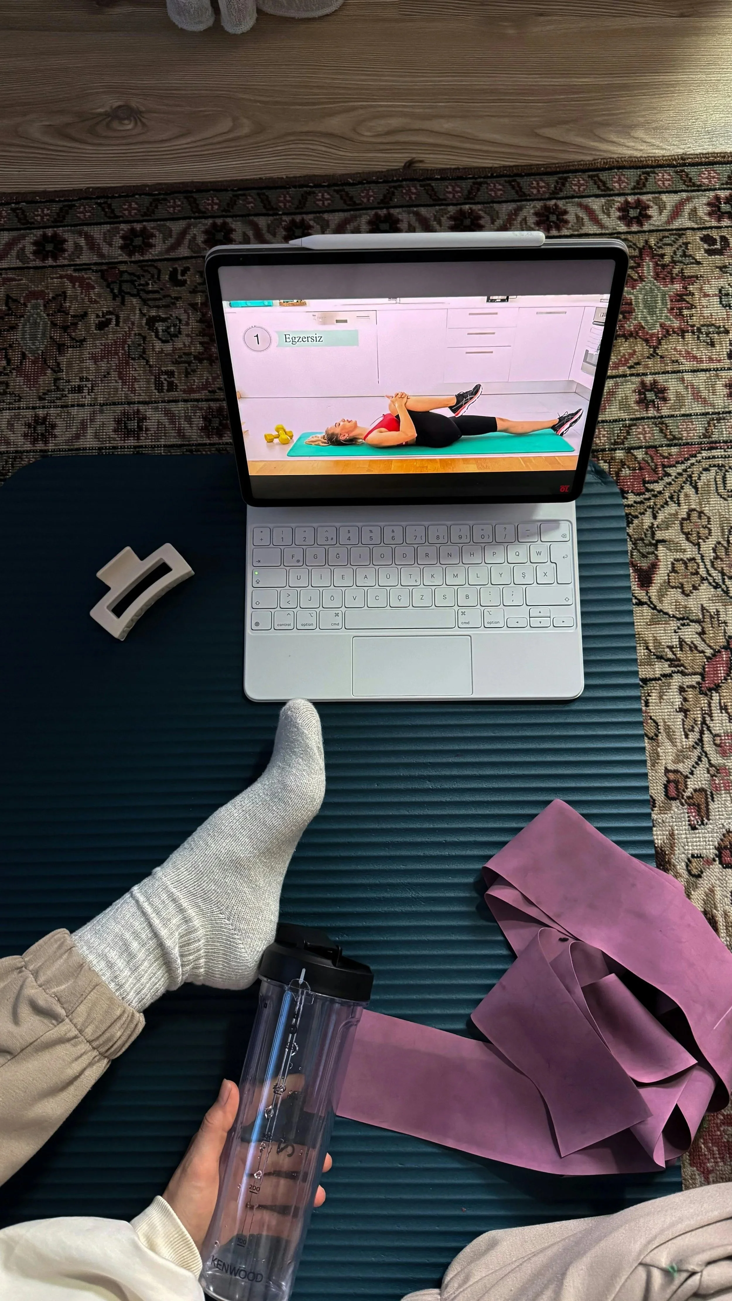 Online coaching workout tools displayed with laptop and resistance bands