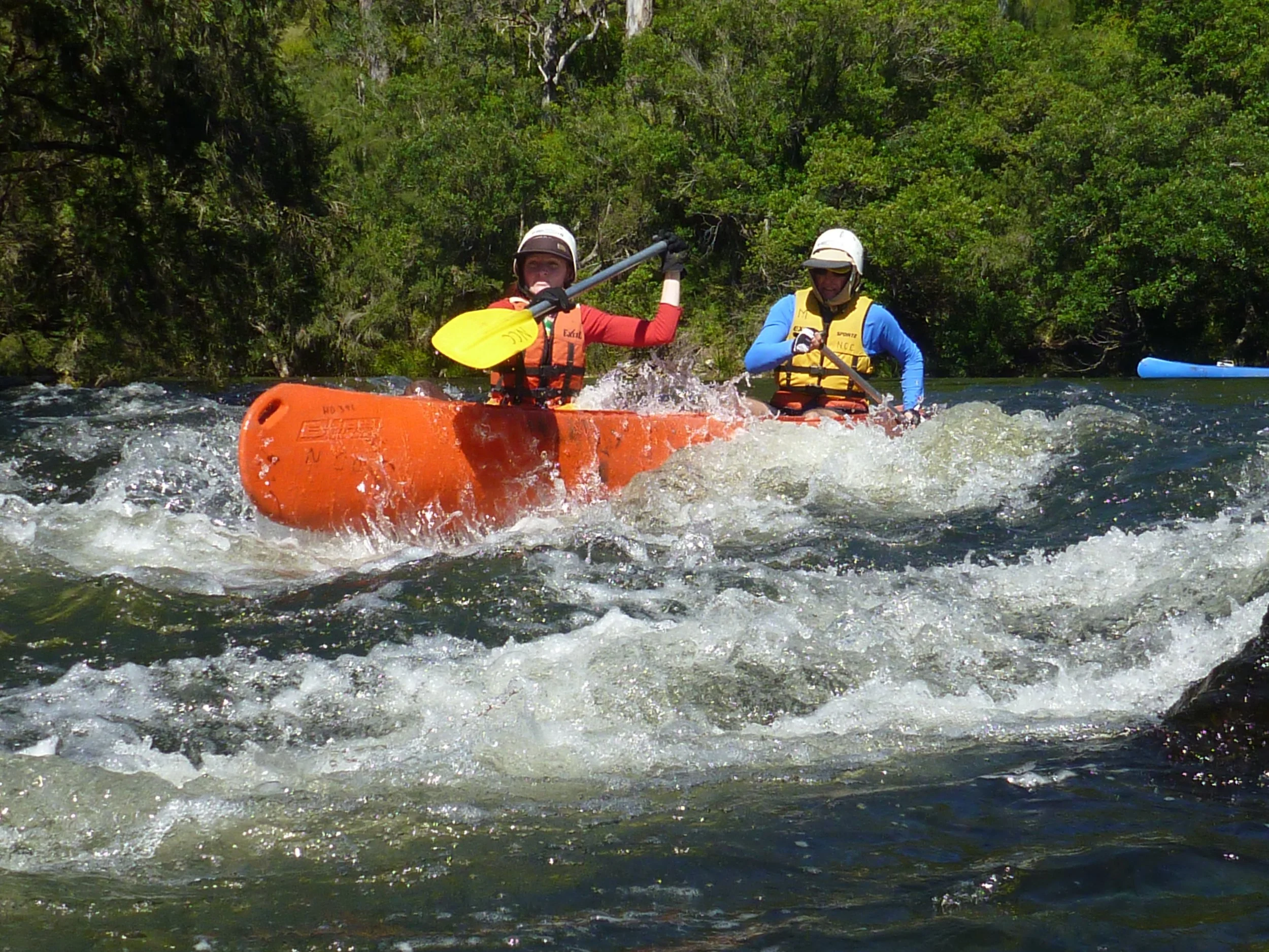 Two people paddling in a canoe.