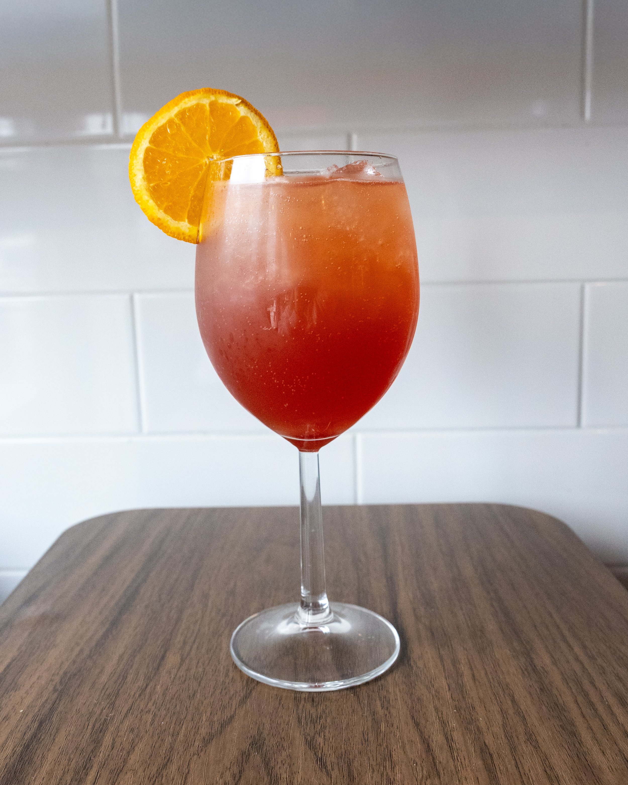  Still Summer Spritz 
NE1 Vodka, aperol, orange juice &amp; blackberry syrup. Topped with soda &amp;
garnished with a orange wheel.