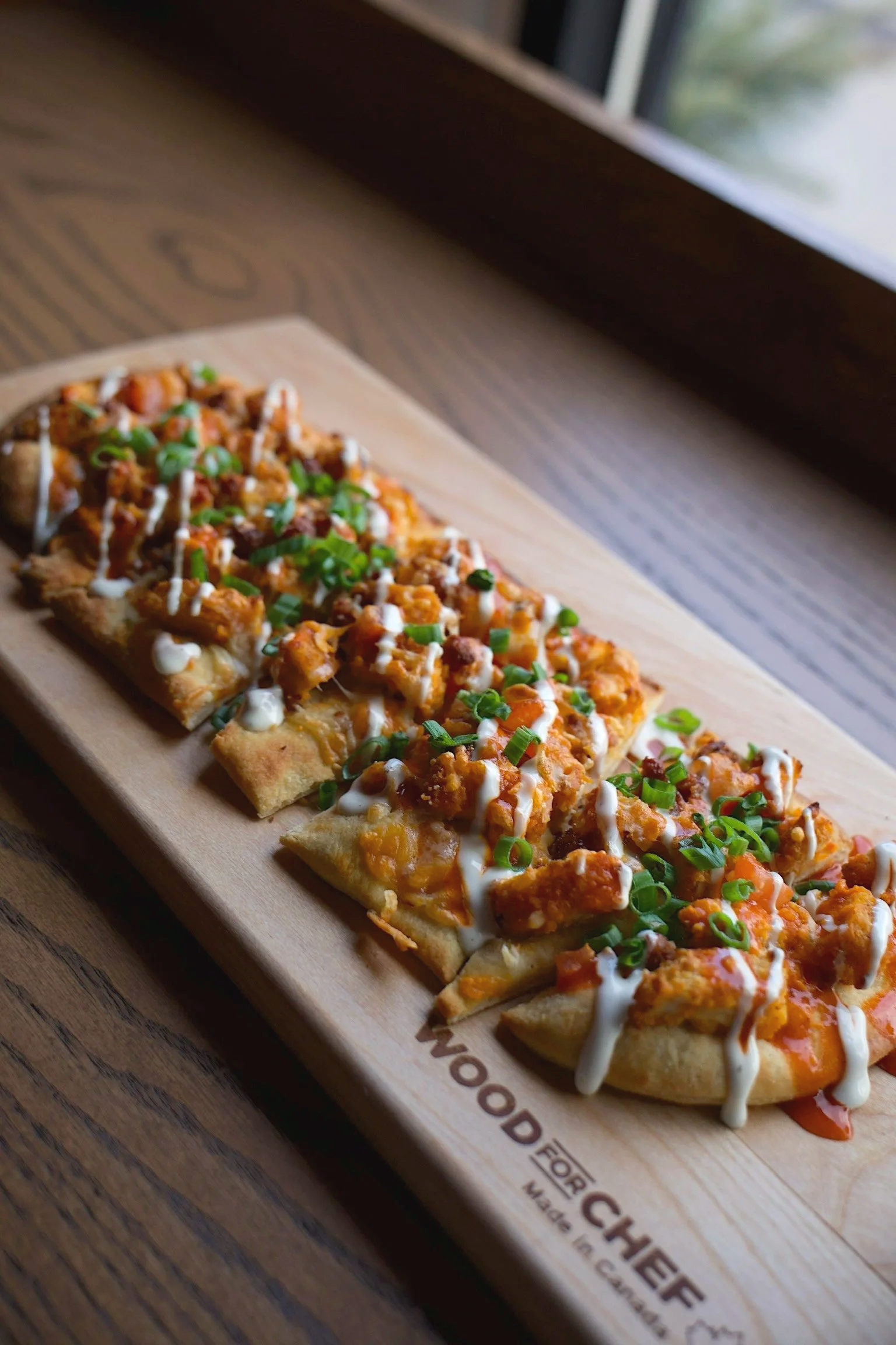  Buffalo Chicken Flatbread 
Crispy chicken coated in buffalo sauce. Finished with shredded cheese, tomatoes, bacon and drizzled with ranch.