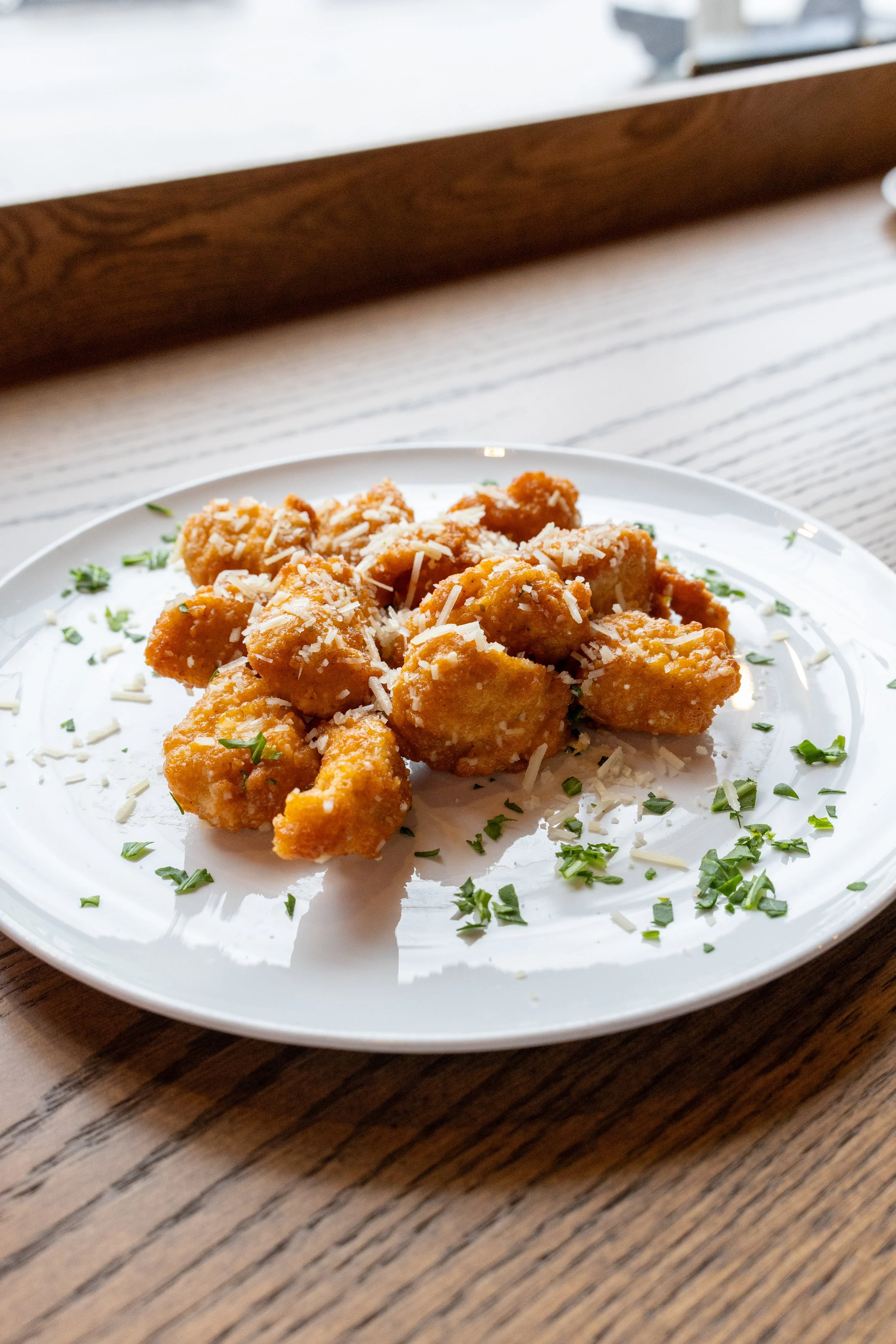  Garlic Parmesan Chicken Bites 
Crispy chicken chunks coated in buttery garlic sauce with fresh Parmigiano Reggiano cheese