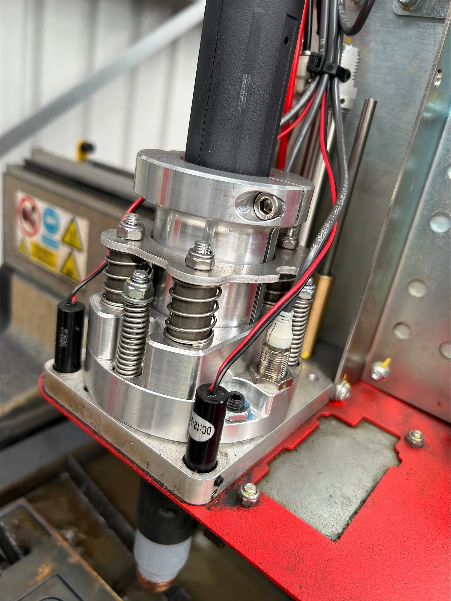 Custom independent floating Z with breakaway sensing for use with Hypertherm mechanized plasma torches.