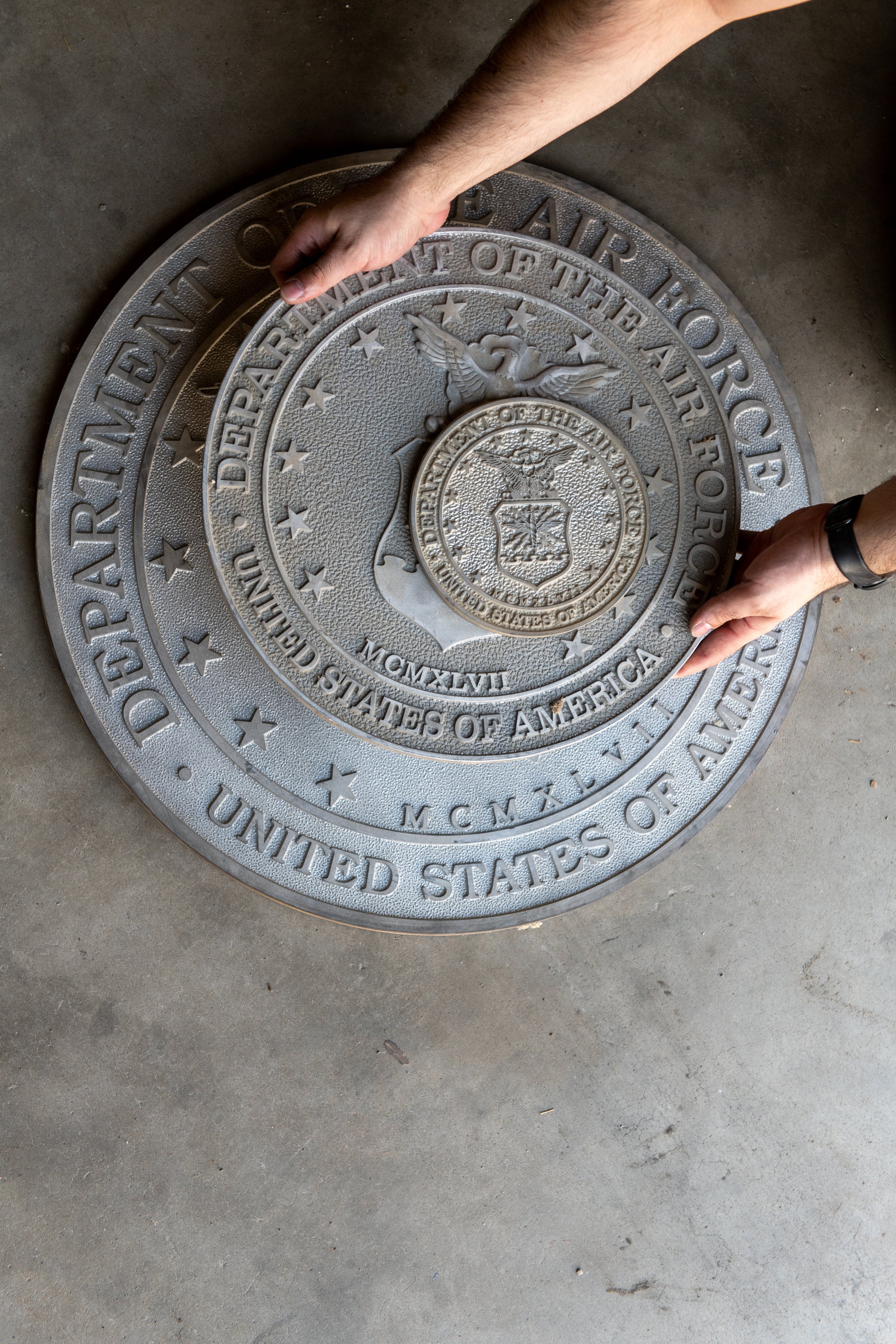Historic cast metal military seal undergoing plaque restoration to preserve detail, readability, and long-term durability.
