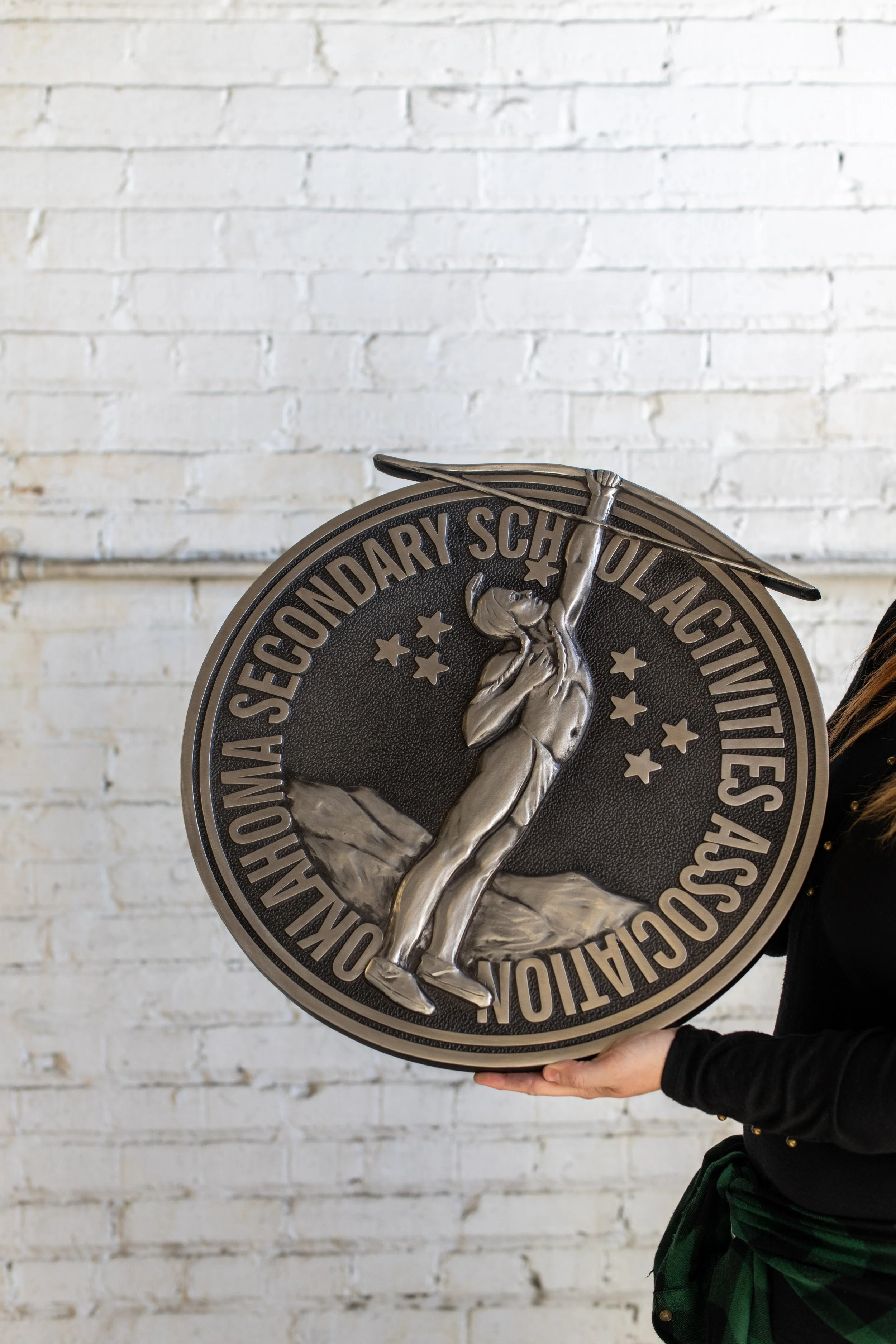 Custom cast metal plaque for Oklahoma Secondary School Activities Association featuring dimensional cast metals craftsmanship and durable commemorative signage design.