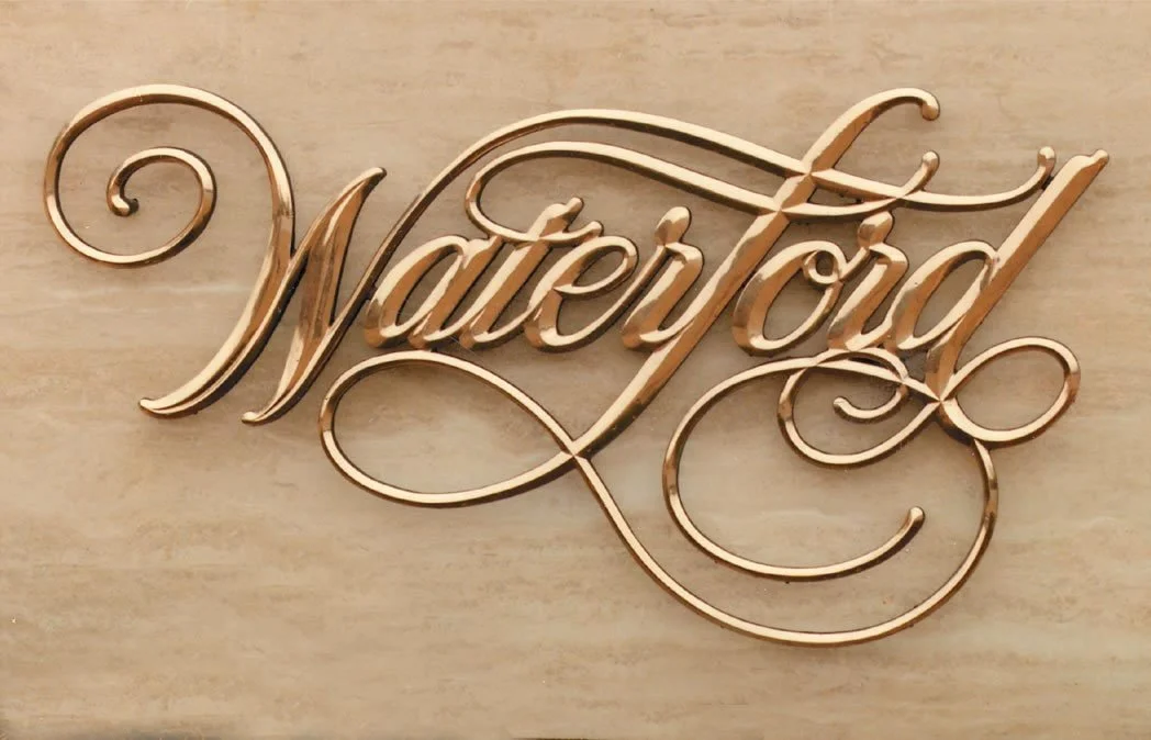 Custom logo signage featuring elegant dimensional metal lettering, showcasing custom signs for business with premium craftsmanship and professional architectural branding.