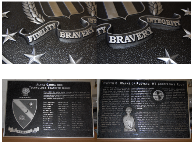 Close-up detail of raised lettering and textured background on a cast metal sign.