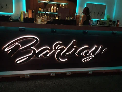 Illuminated channel letter signage for a hospitality venue featuring custom metal signage and premium building signage with modern lighting.