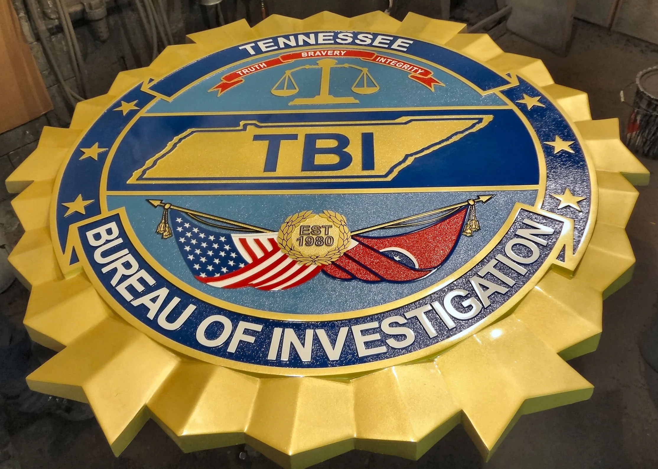 Custom Tennessee Bureau of Investigation (TBI) emblem featuring a precision-cast, full-color design with the state outline, American and Tennessee flags, and the motto 'Truth, Bravery, Integrity.' Durable and detailed for official use.