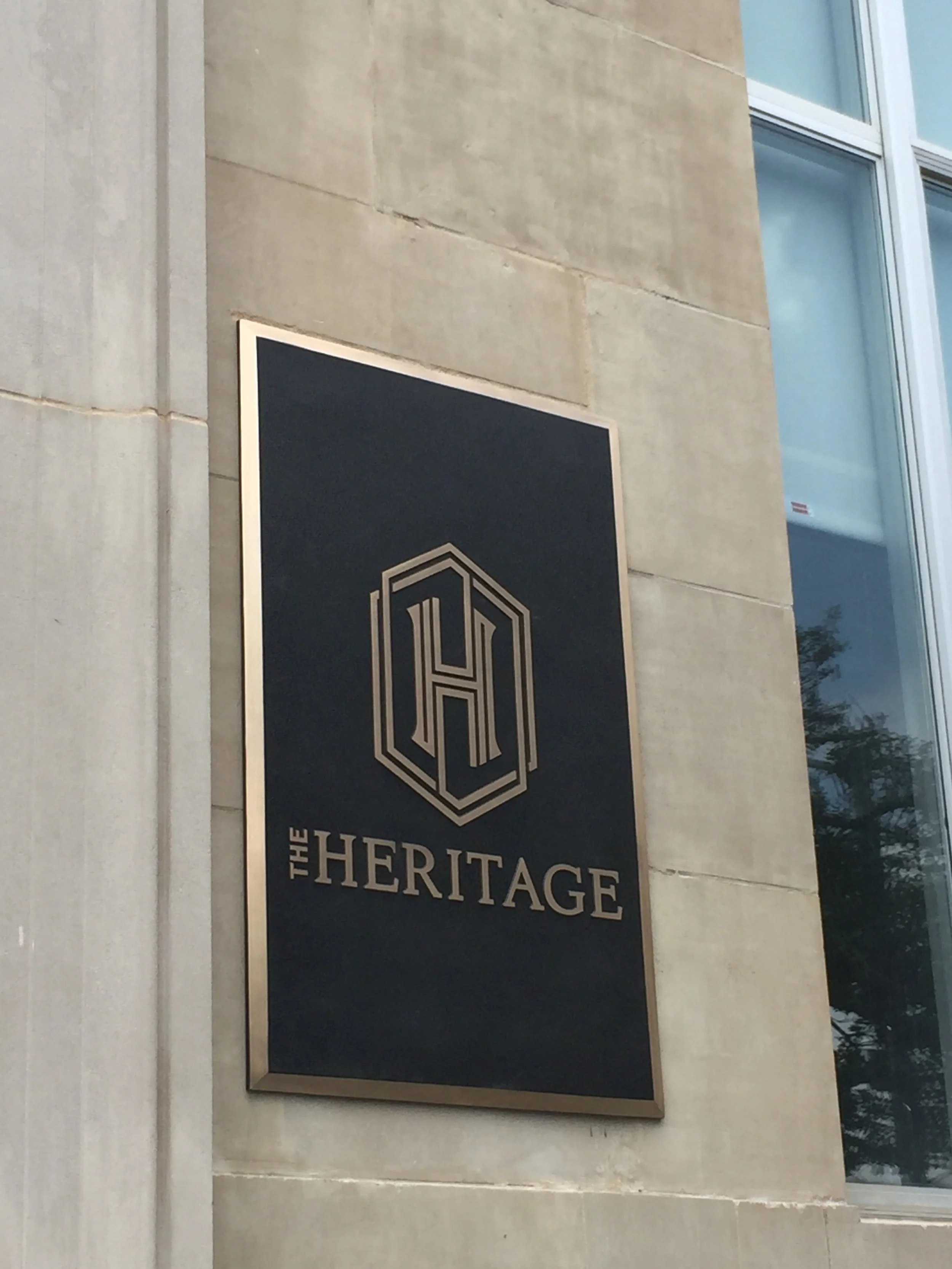 Custom architectural signage for The Heritage featuring dimensional lettering and premium metal finishes, showcasing durable signage and American made architectural signage for residential properties.
