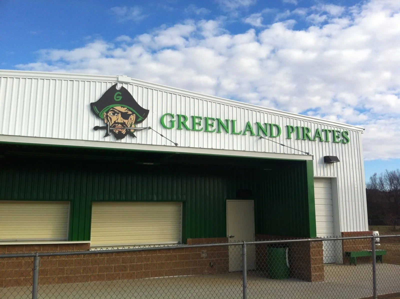 American made architectural signage with custom dimensional lettering and mascot graphics installed on an athletic facility, demonstrating durable signage for schools and public spaces.