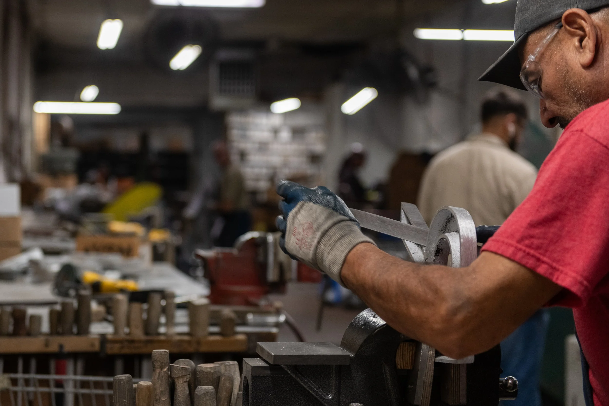 A.R.K. Ramos craftsman finishing custom metal logo signage for branding signage designed for professional brick and mortar locations.