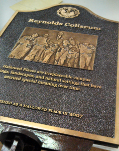 Historic Reynolds Coliseum plaque undergoing sign restoration and refinishing metal by A.R.K. Ramos to preserve legacy details and original craftsmanship.
