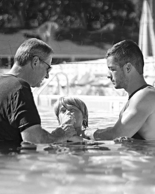 Pastor Greg baptizing young man
