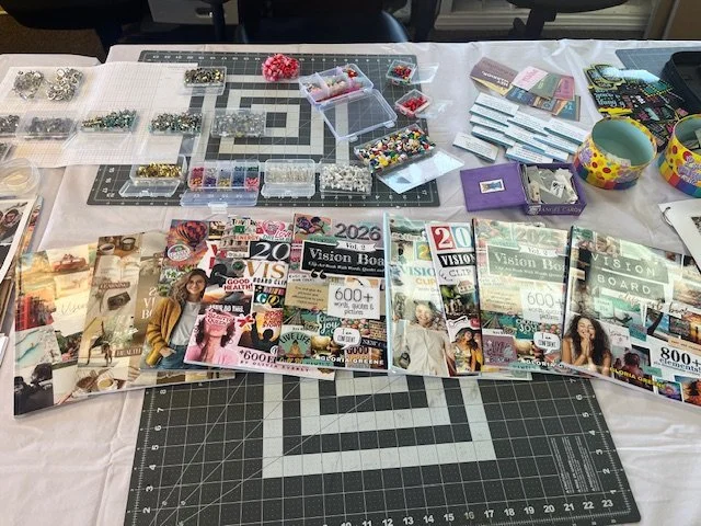 Tables with magazines, bead organizers, craft supplies, and stacks of notebooks or planners.