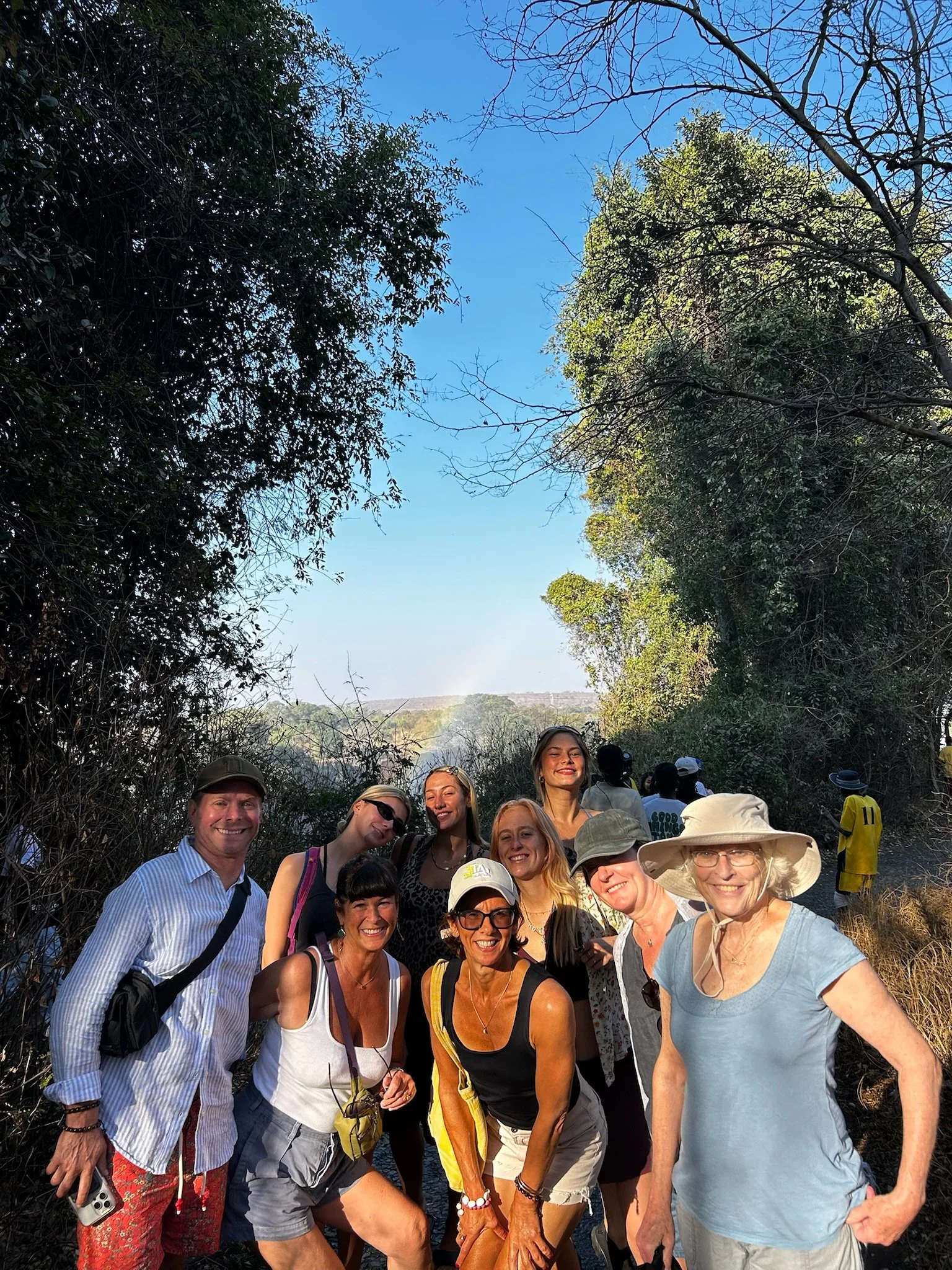"Group photo at Victoria Fall's with rainbows and smiles on Together we Breathe's Wellbeing and Safari Retreat"