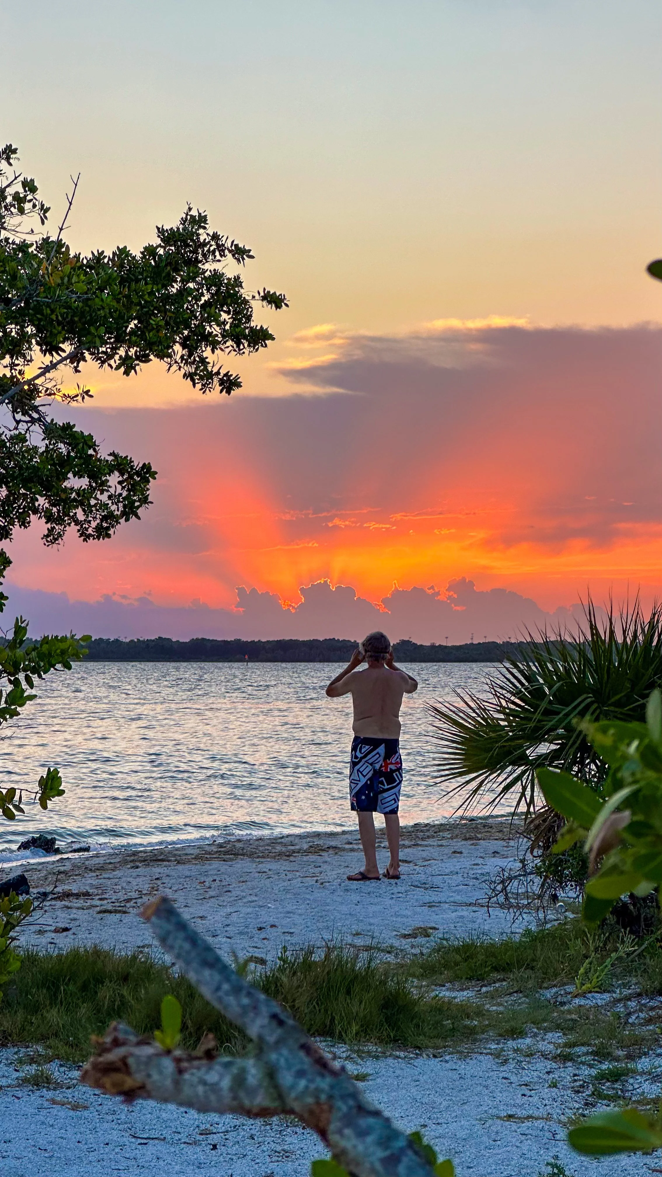 Colorful sunset over the water during a bioluminescence paddle tour near Orlando.