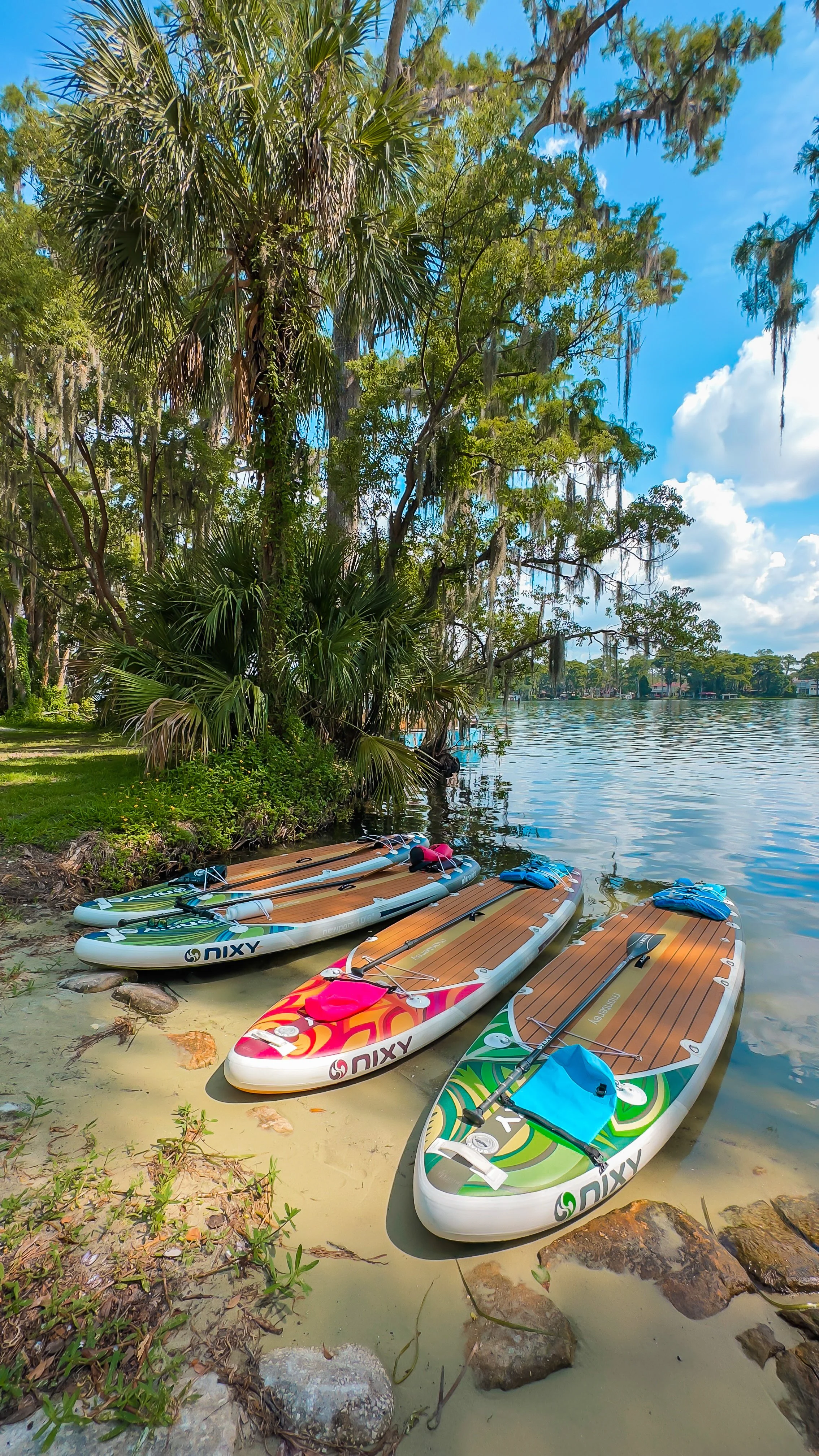 NIXY paddle board on the shoreline at Winter Park Chain of Lakes – premium paddleboard used on Orlando paddle tours