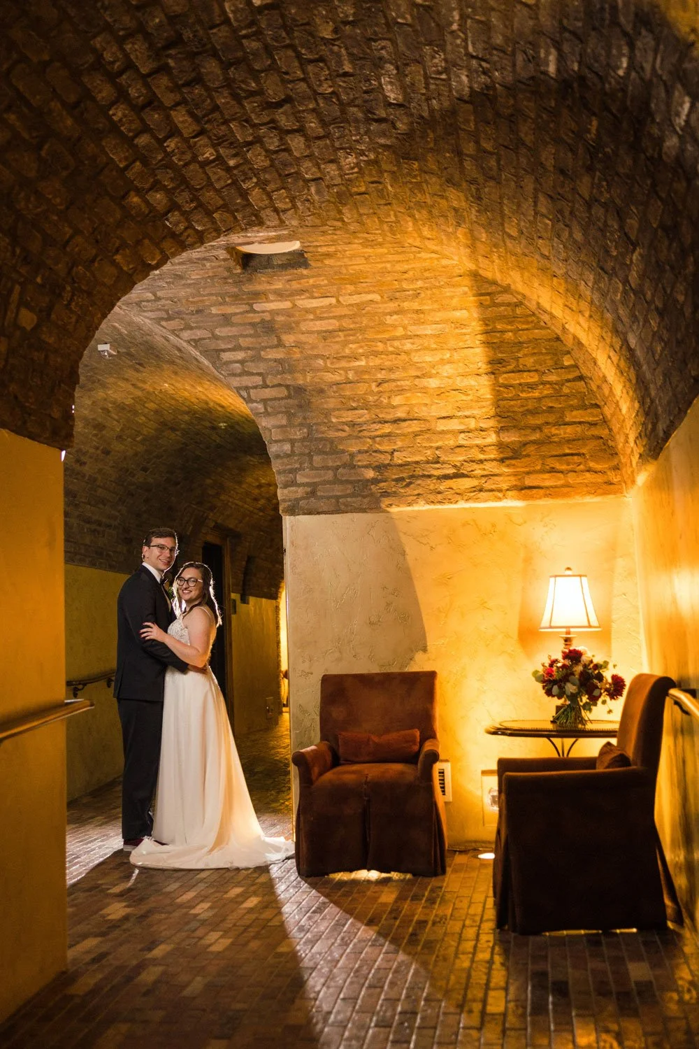 bride and groom photo in wine tunnel, country club ambiance