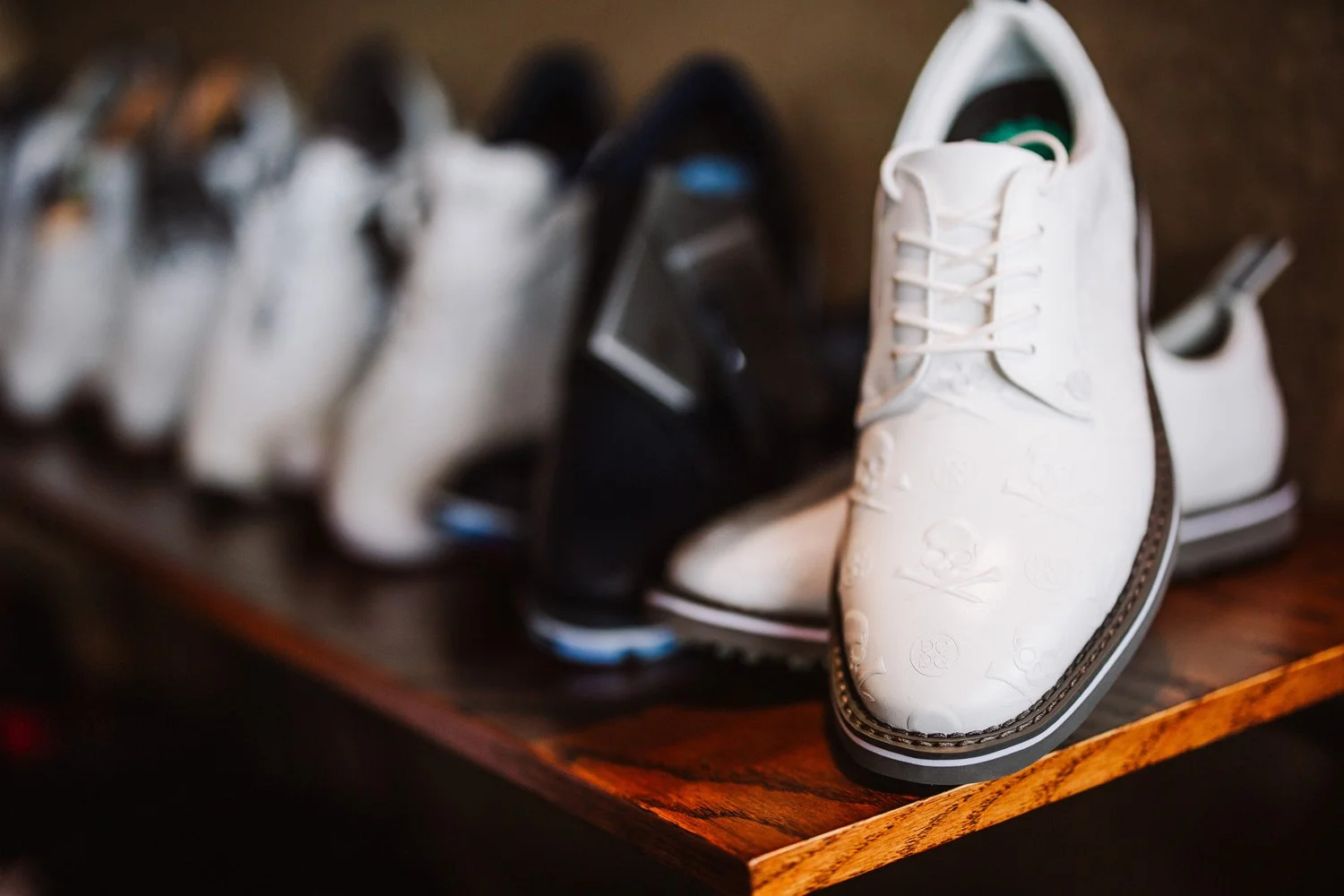 lineup of golf shoes on shelf at the golf shop