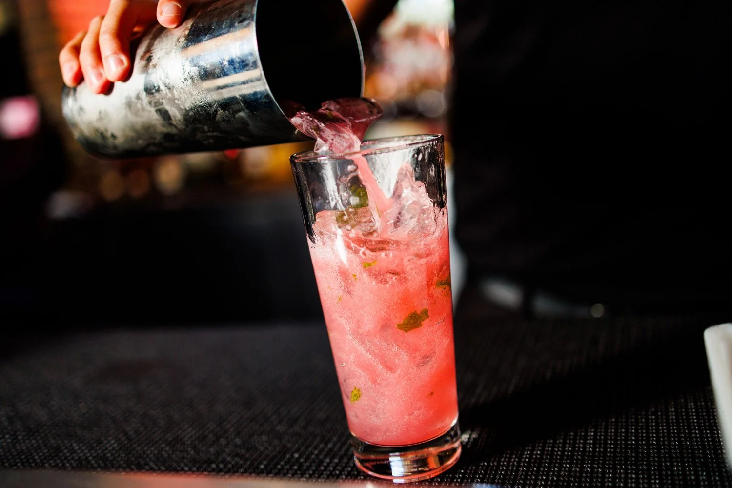 mixology at the bar creating a pink drink