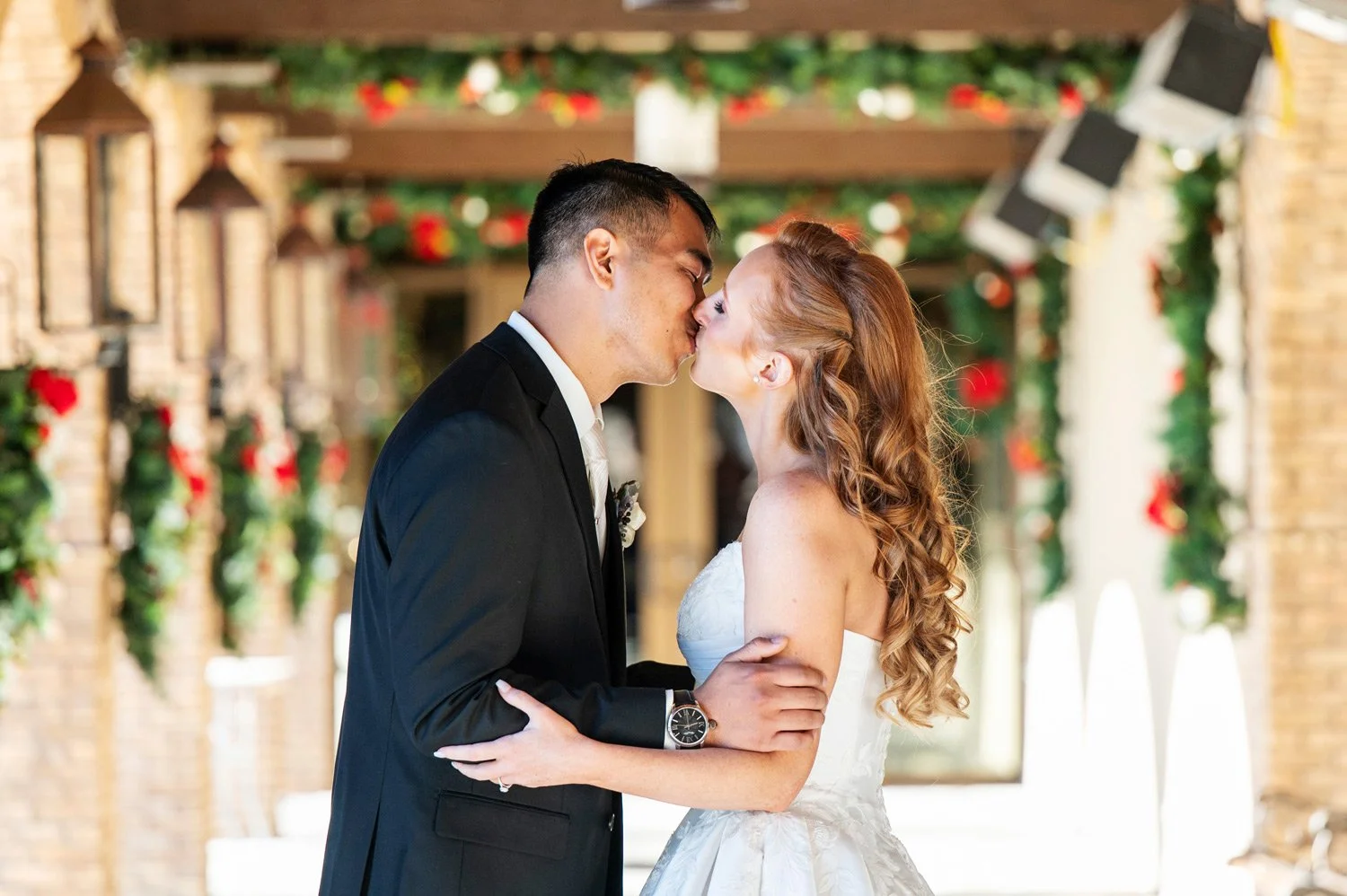 christmas decorations and a couple kissing underneath the garland
