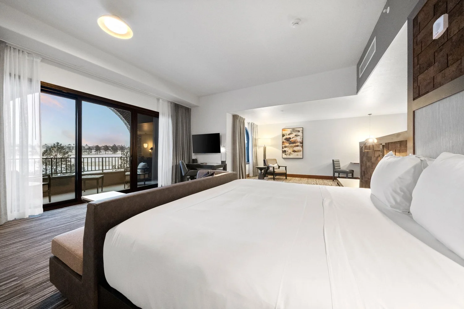 king bed with sliding door to private deck in the academy suite