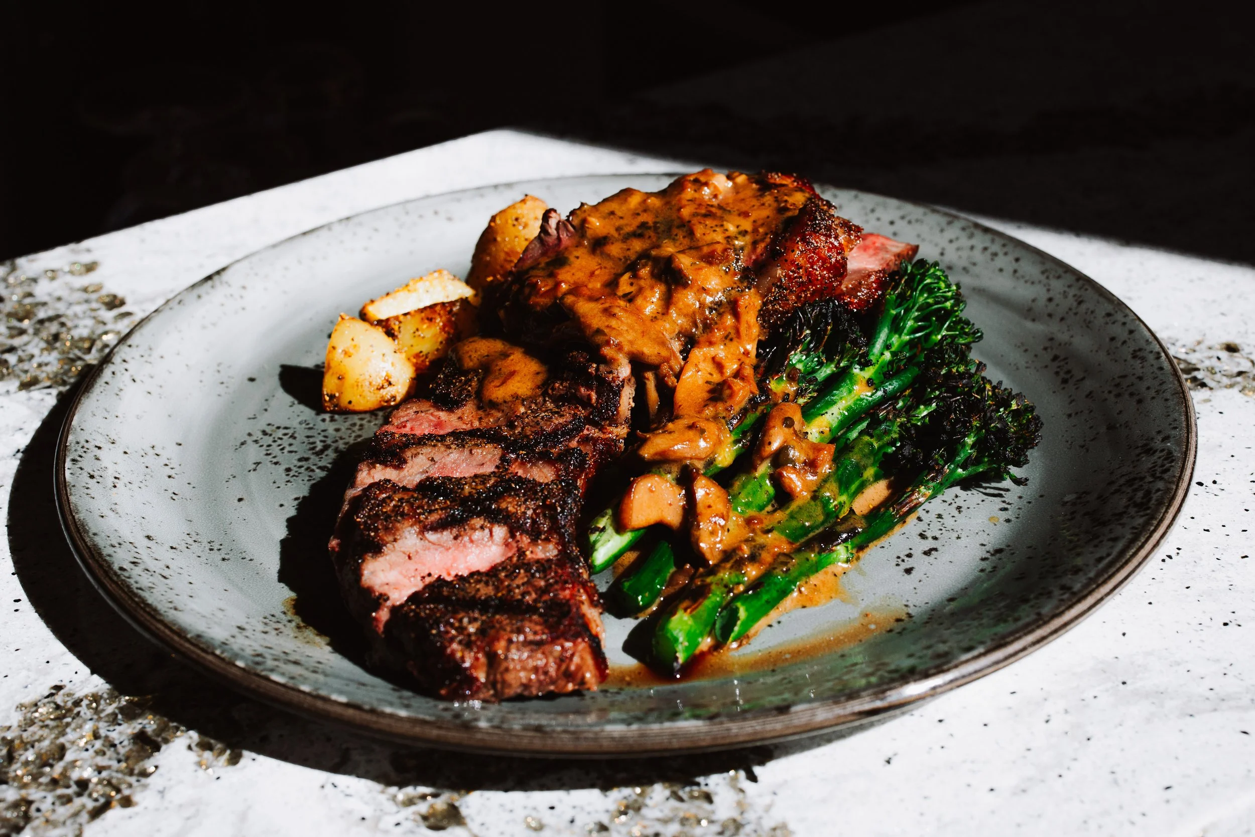 Controfiletto de manzo - 10oz prime NY strip, mushroom sauce, broccolini, fennel pollen roasted potato