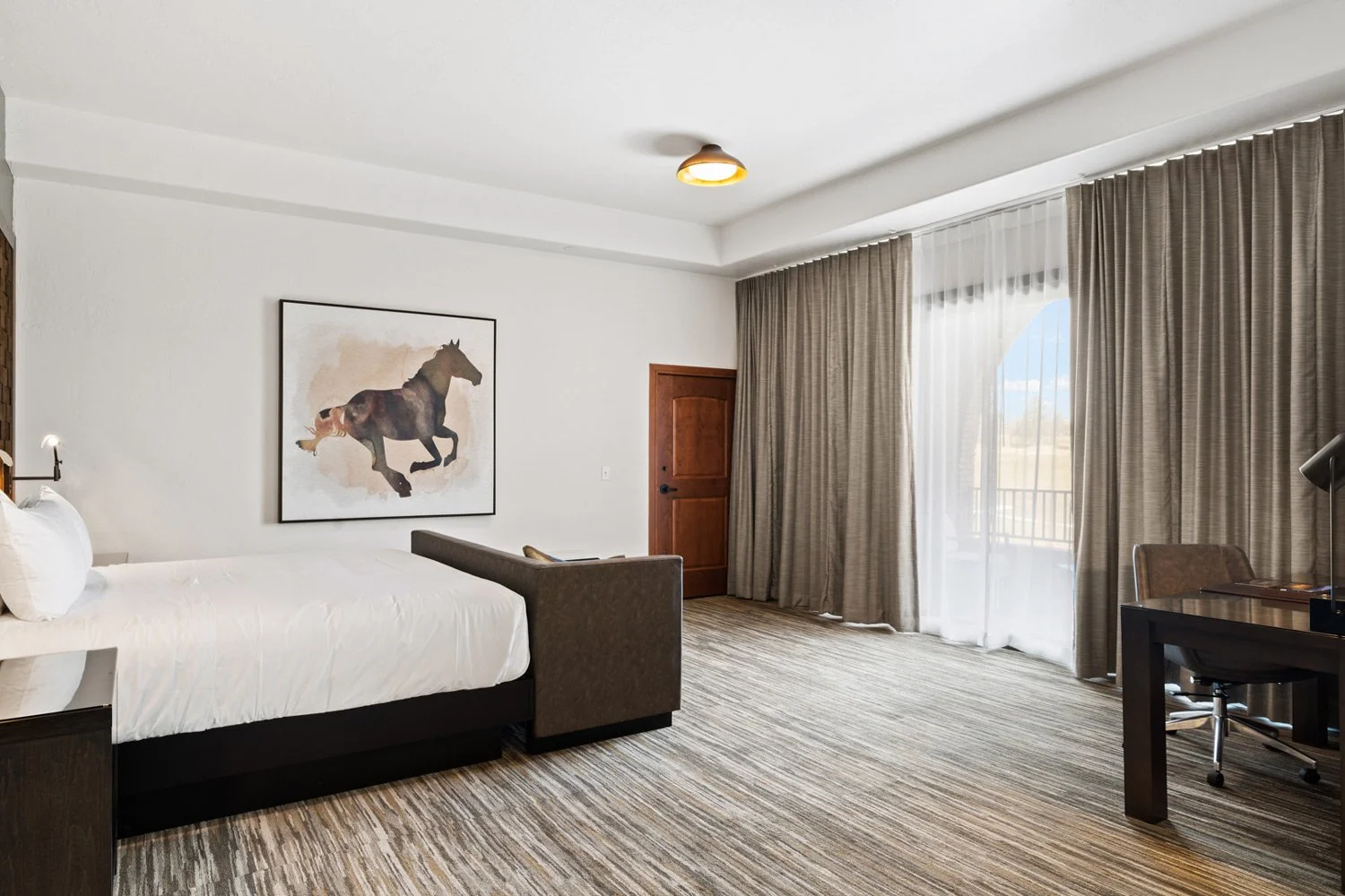 bed and deck sliding door to the private deck in academy suite