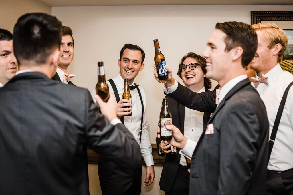 groomsmen cheers in the wine tunnel rooms