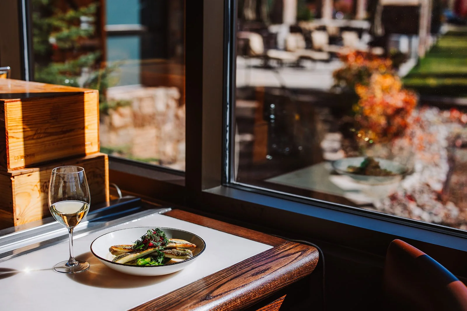 branzino fish paired with white wine and fall views at the steakhouse