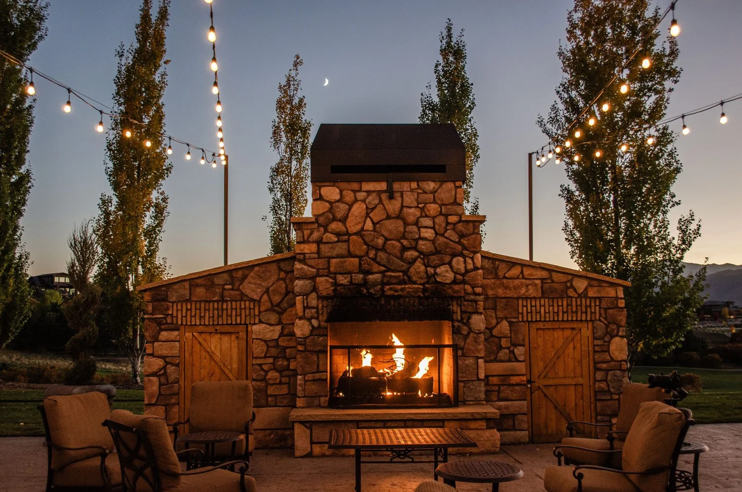 outside of steakhouse evening by the fireplace with bistro lights