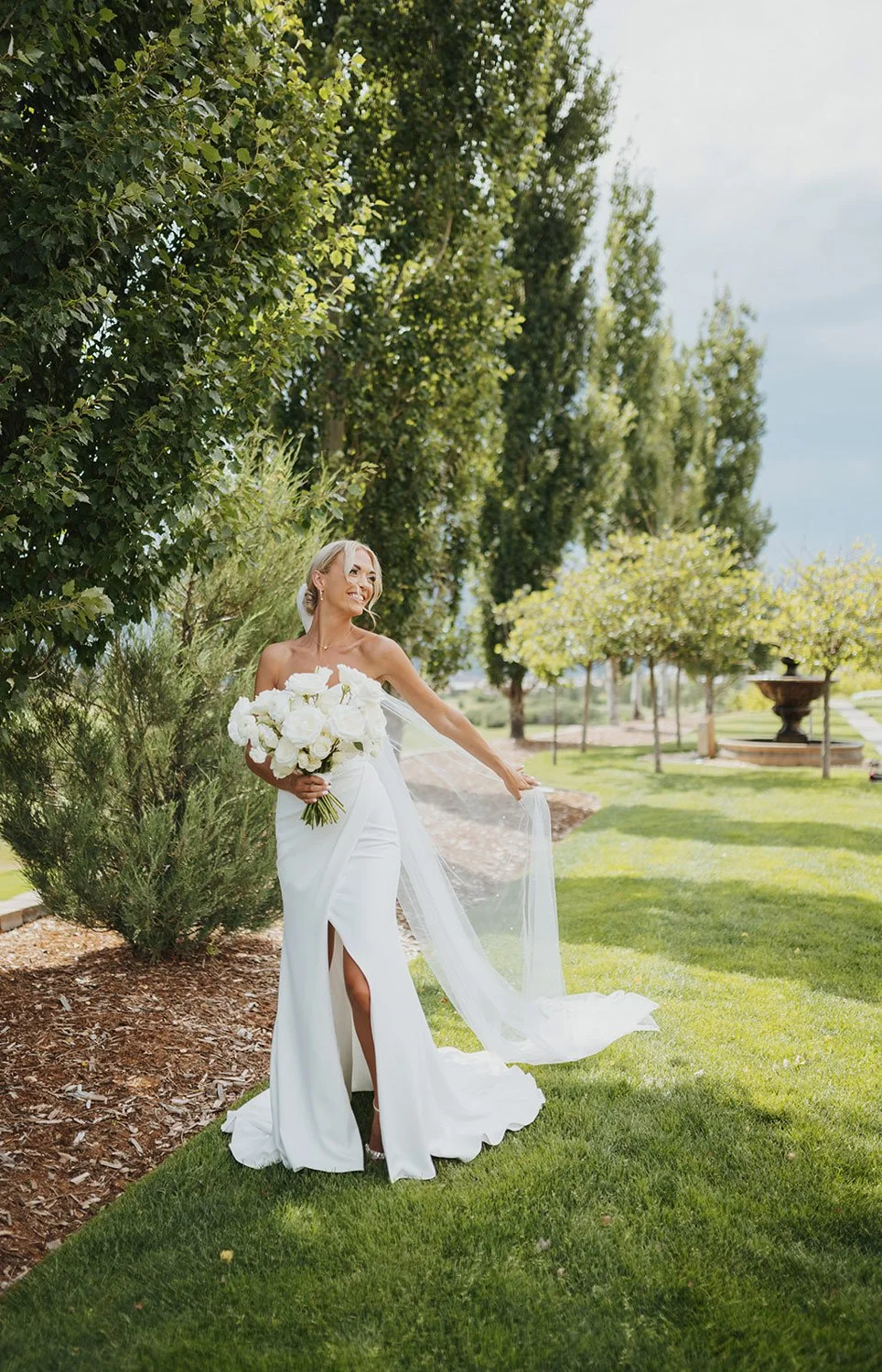 colorado springs bride wearing white wedding dress with white floral bouquet