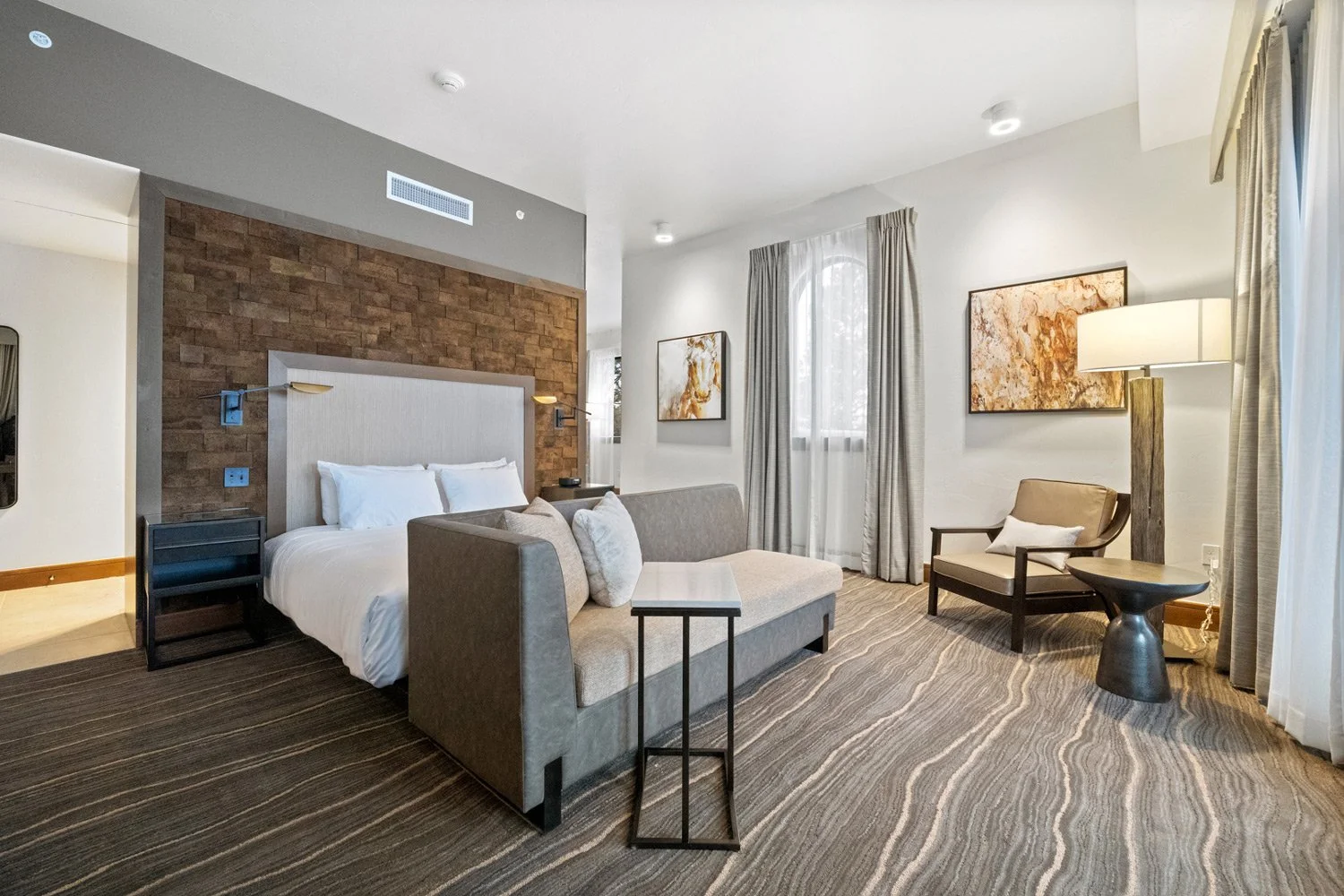 bed in the deluxe suite with couch