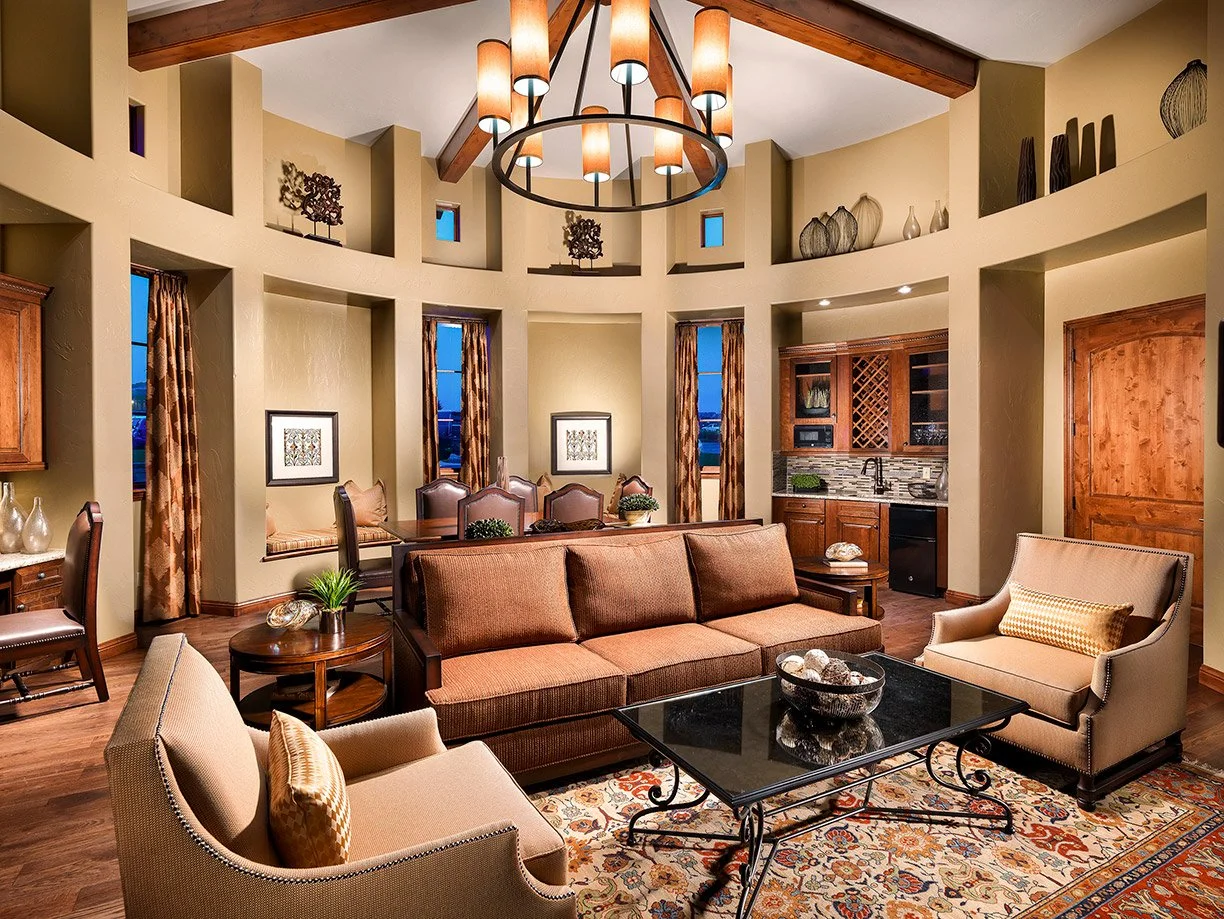 parlor in a villa with grand table, couch, chairs and Tuscan light fixture