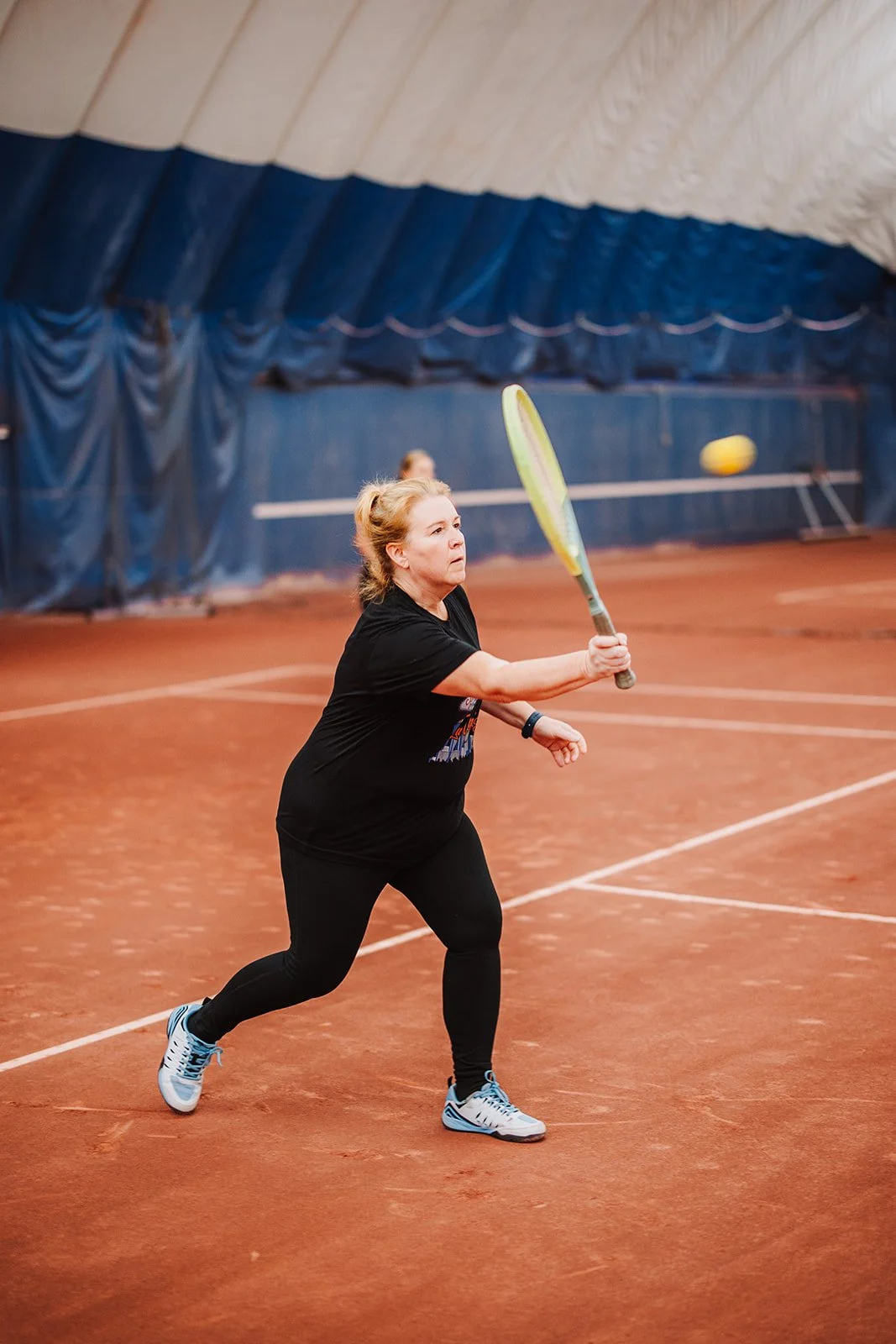 tennis volley in the indoor red clay courts