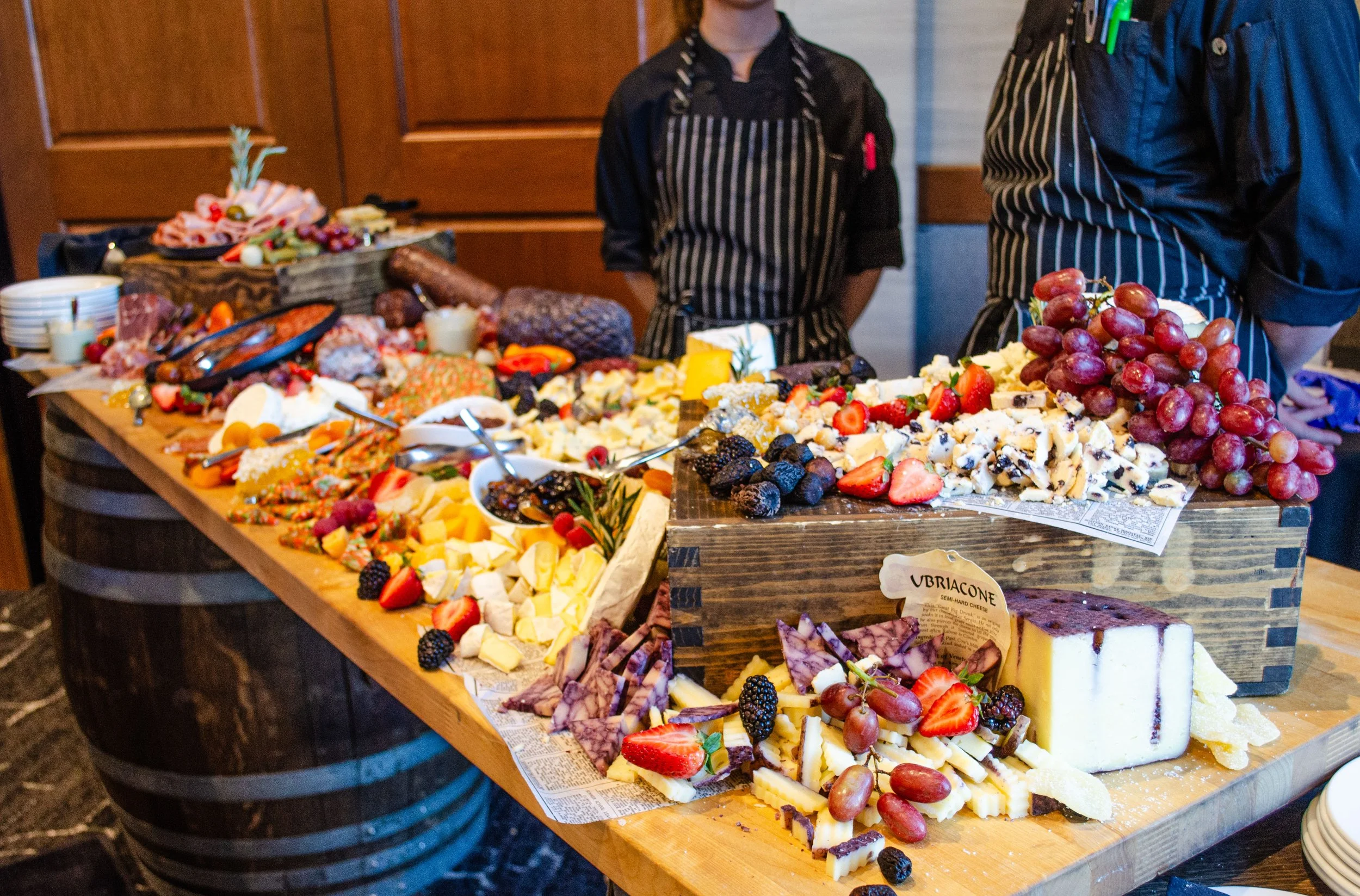 charcuterie board with fruit, cheese, meat and crackers