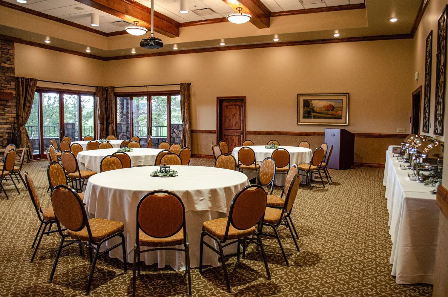 Milano banquet room tables setup with a breakfast buffet and available projector for use