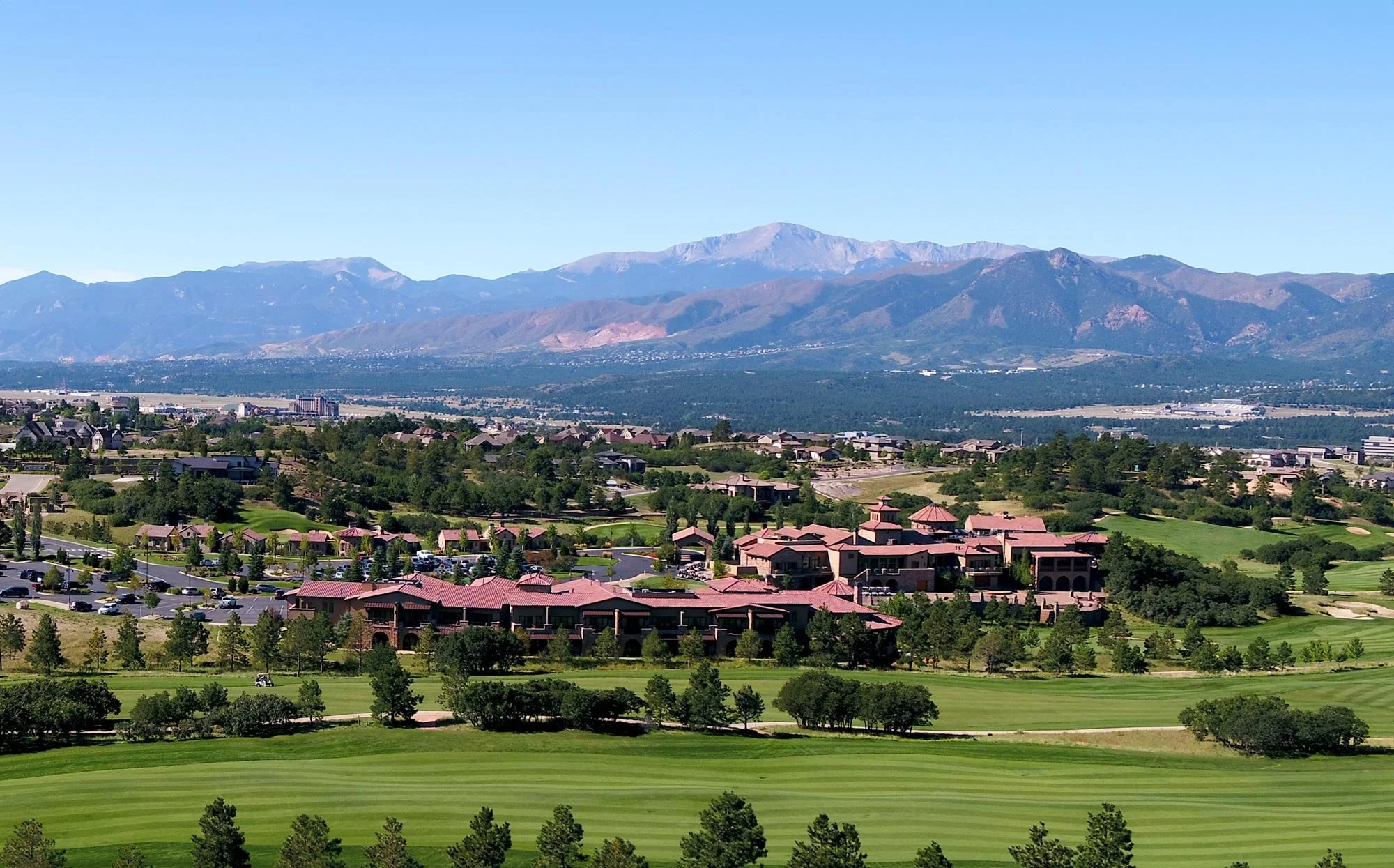 aerial image of hotel and clubhouse looking west at the rocky mountains