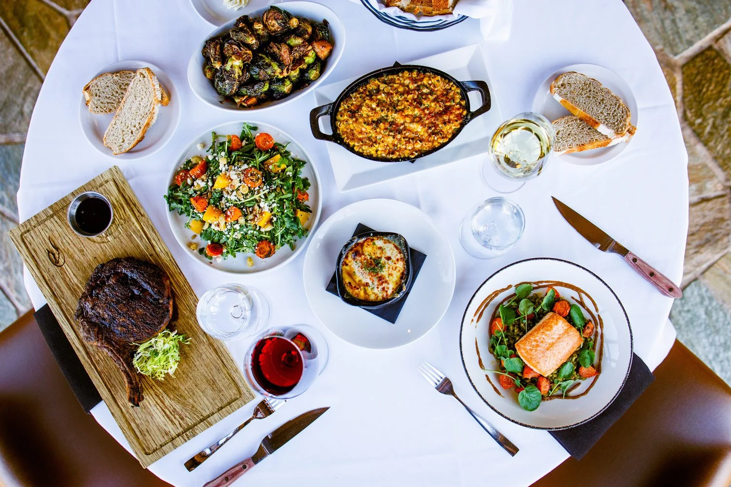 dinner at the steakhouse top down view of a variety of plates and dishes