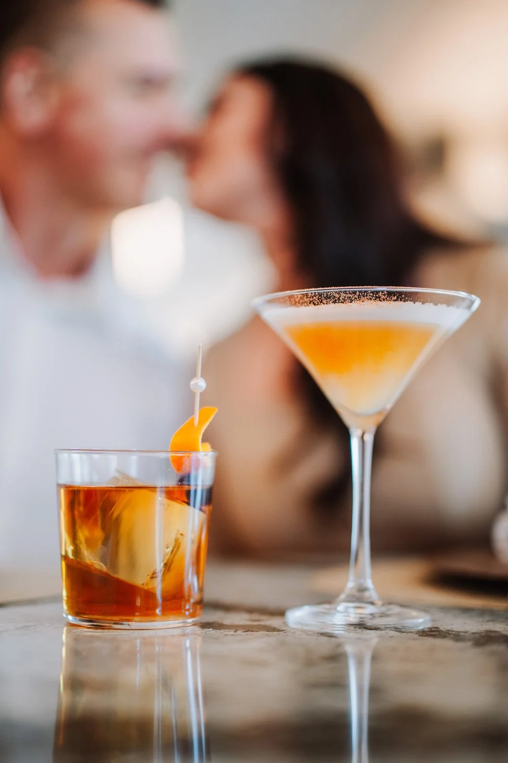 two cocktails on the countertop bar at fortezza italiana with a couple in the background