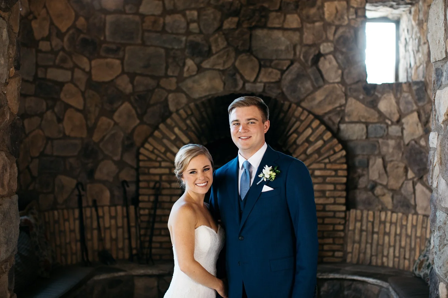 country club wedding photo in front of fire place stones