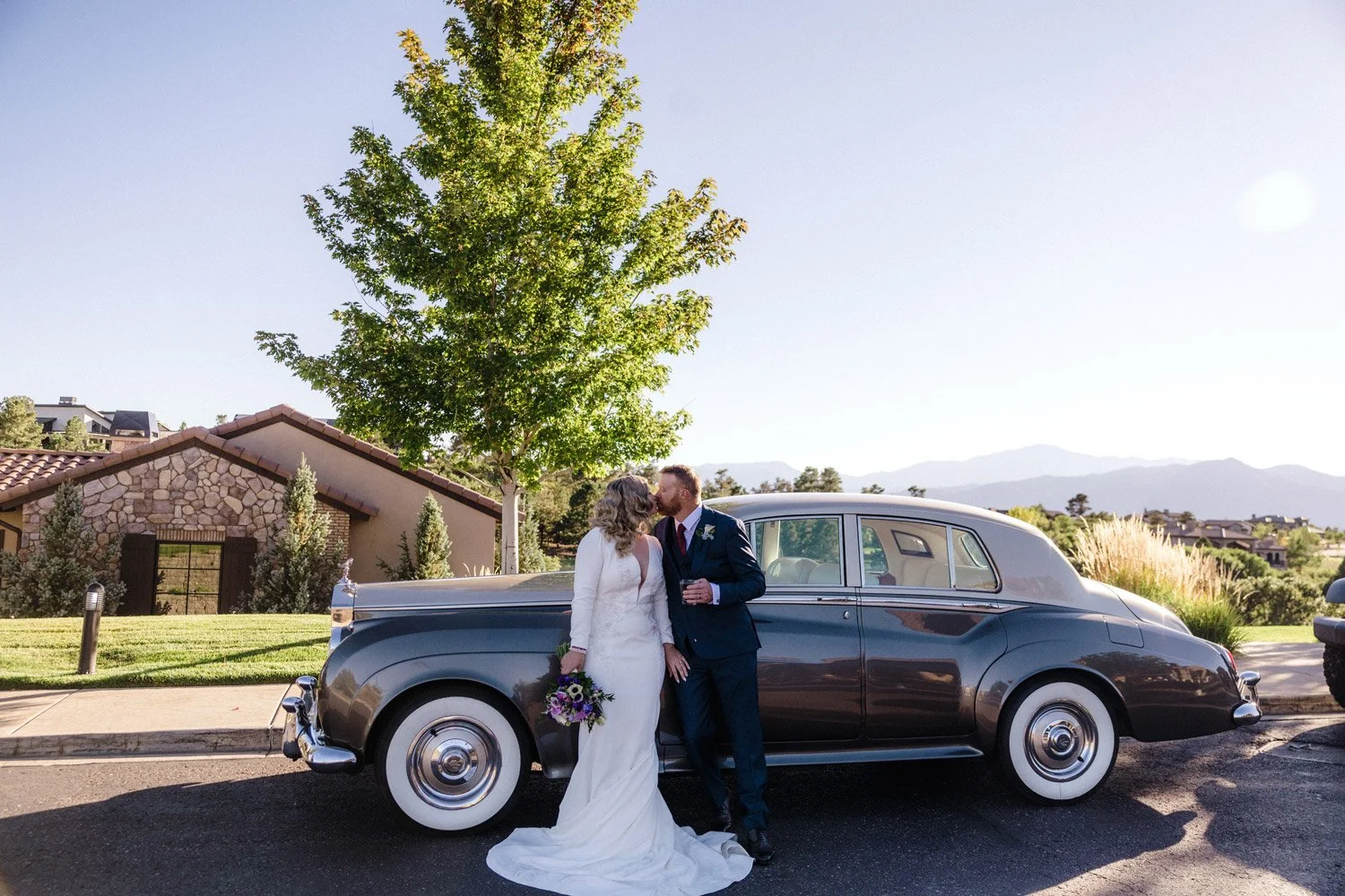 bride and groom with vintage car