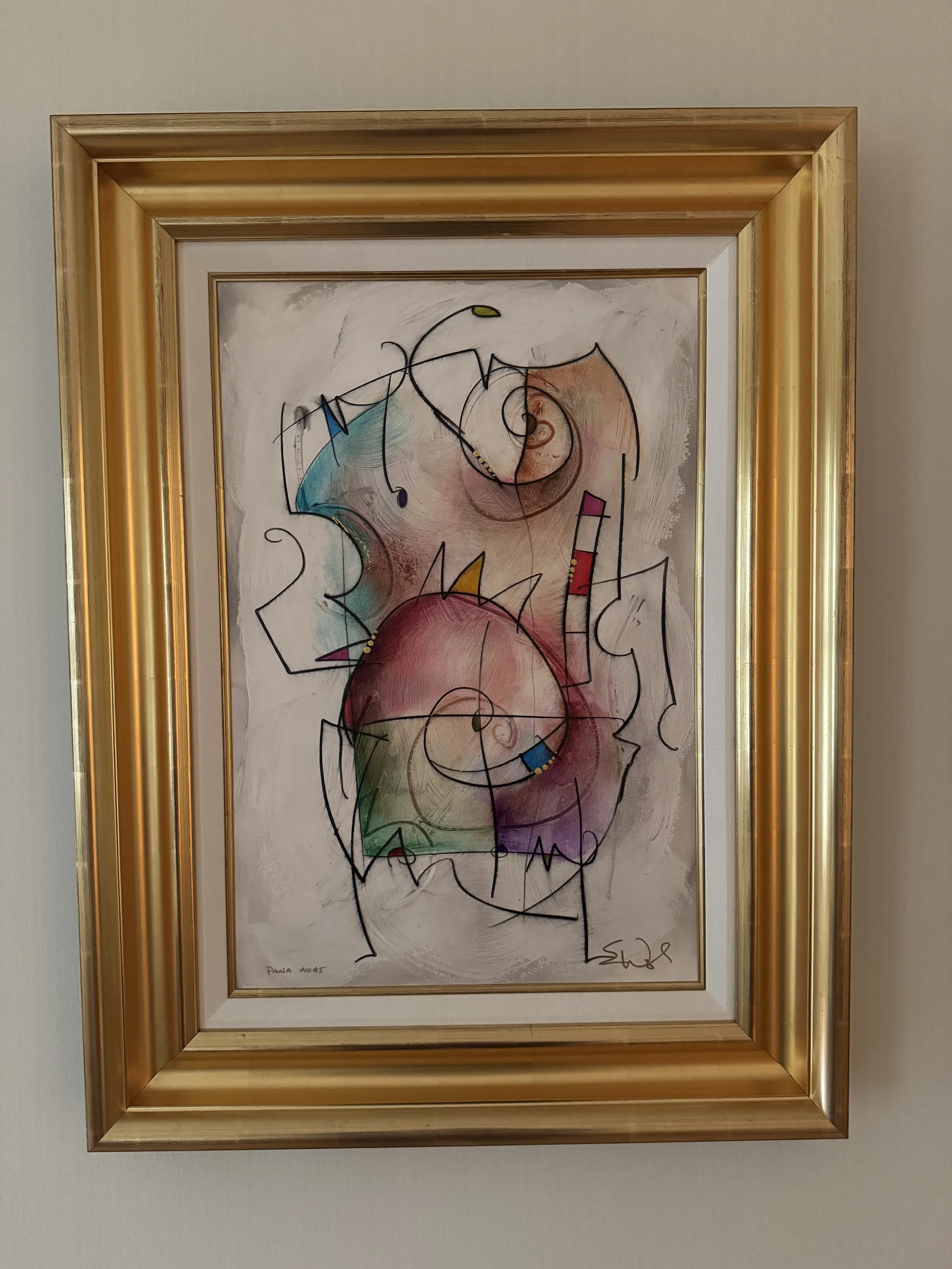 Abstract watercolor painting with swirling shapes and colors, featuring black line accents, framed in gold and white.