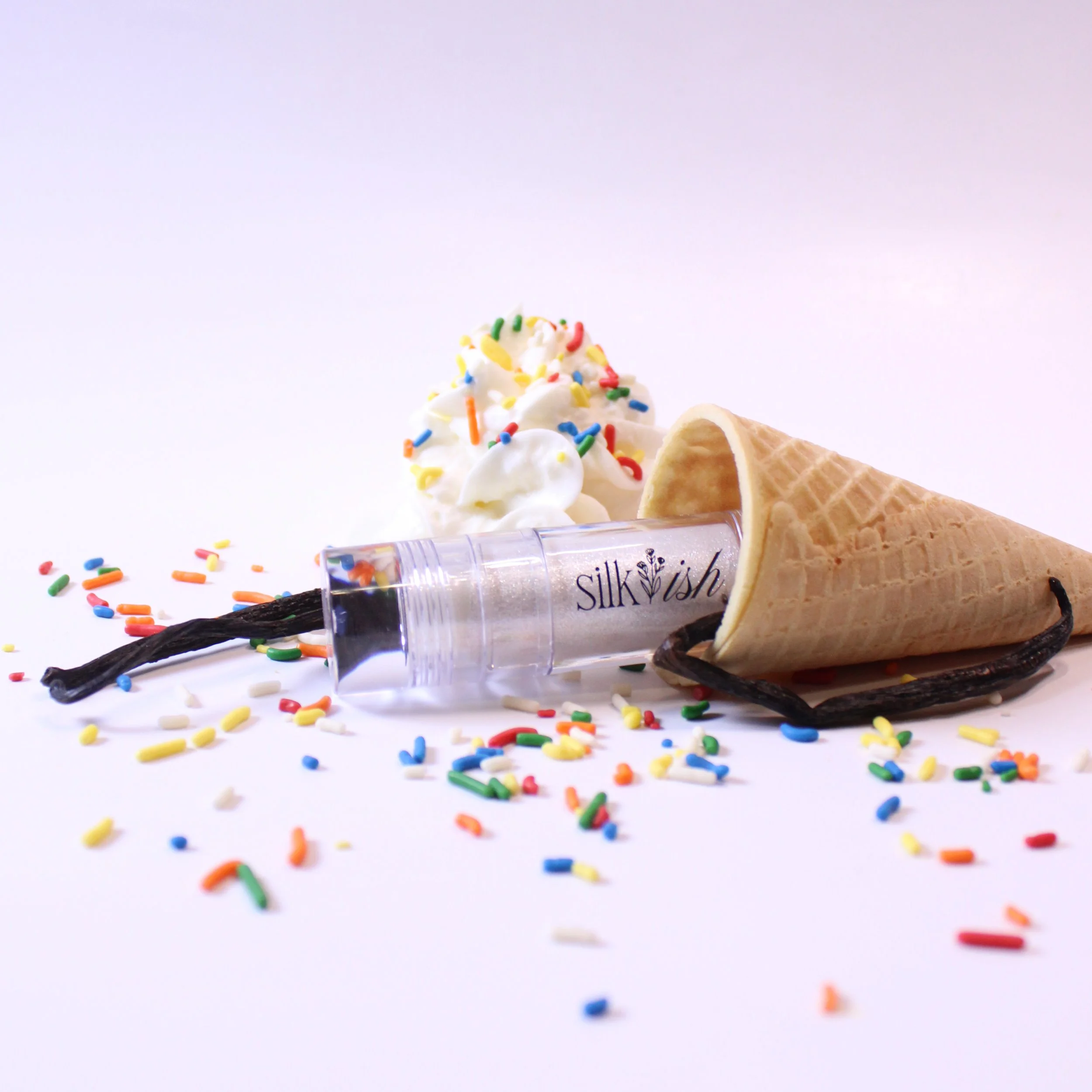 White eye shadow in ice cream cone with whip cream, vanilla and sprinkles
