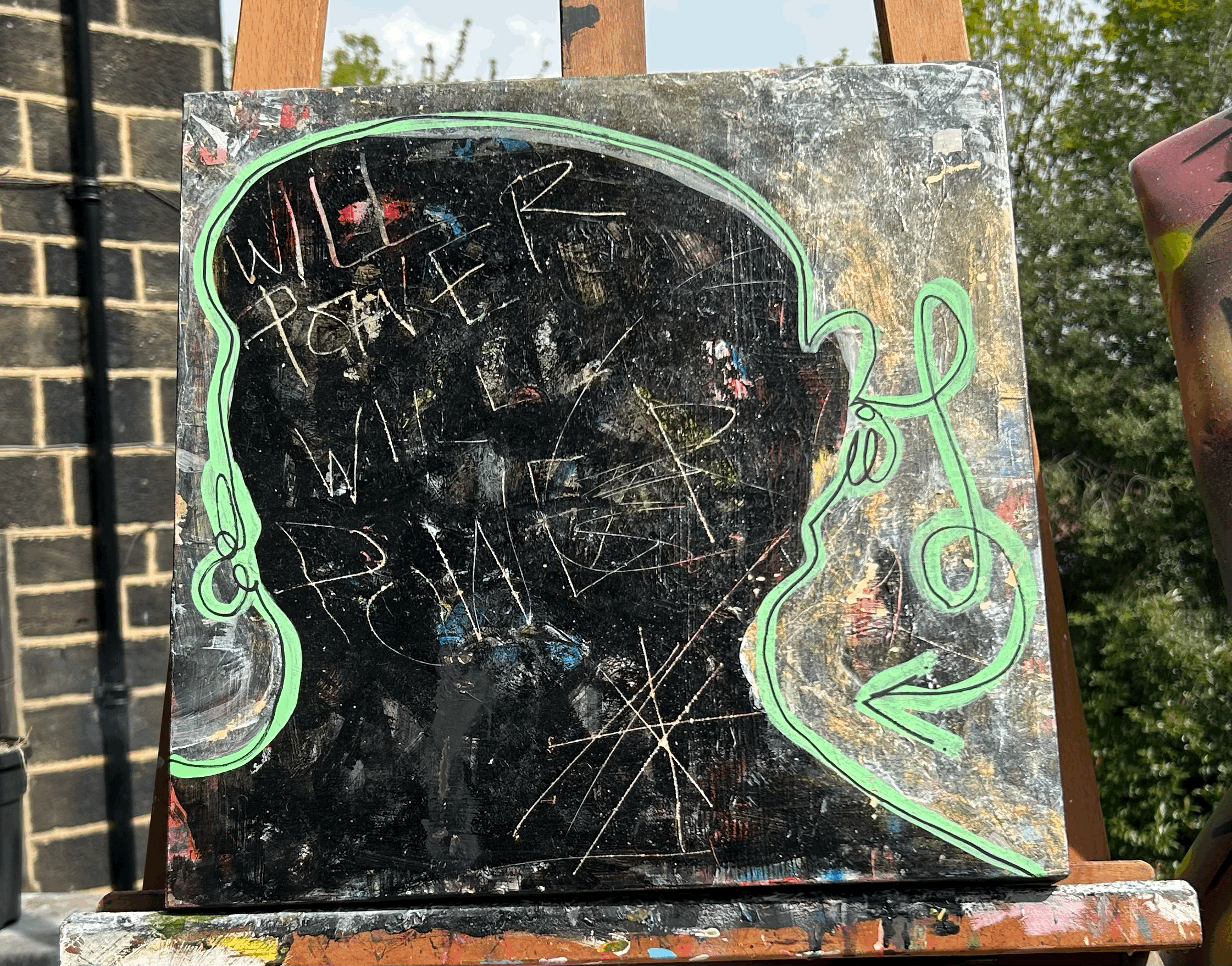A chalkboard with graffiti and a neon green outline of a woman's silhouette, with the words 'WILL I PAY THE PRICE WITH LOVE' written inside.